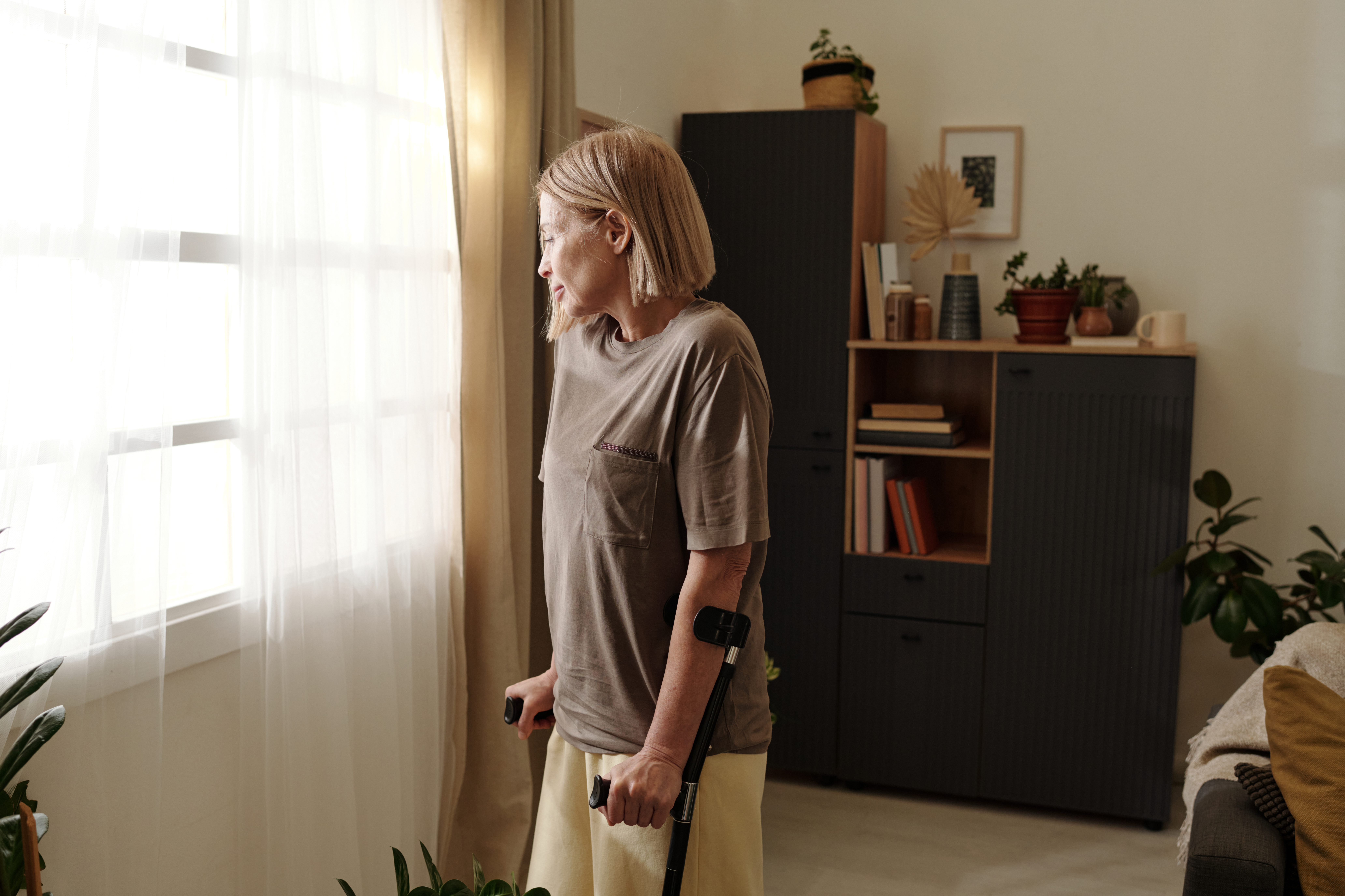 elderly woman looking out window with calm express 0134fbaa69065650464f