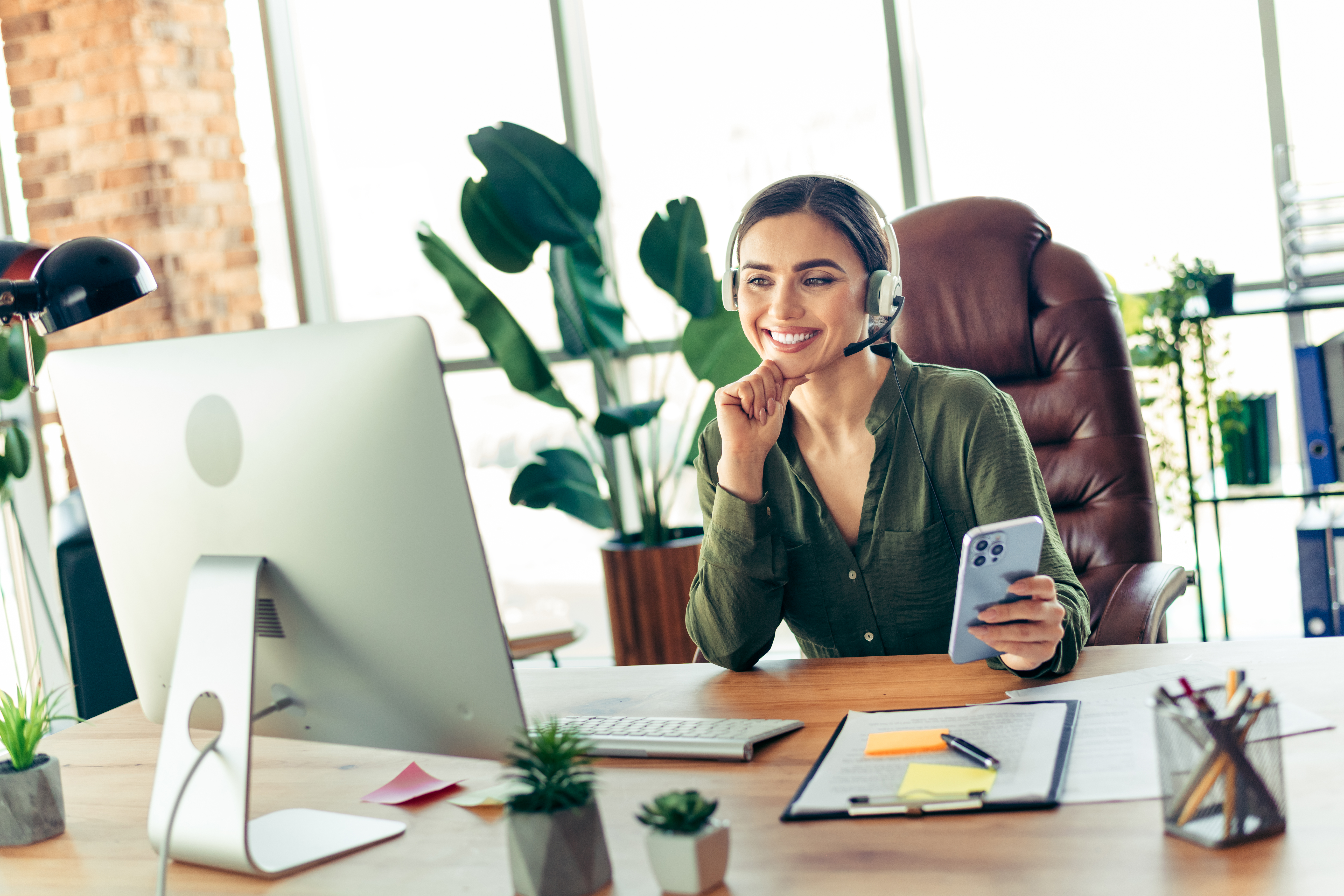 elegant young businesswoman wearing a headset at h 9bd615082413d5ae171d