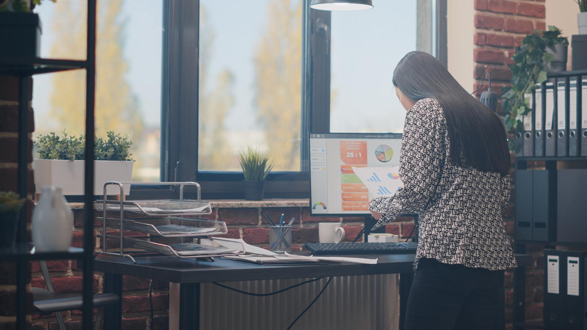Employee analyzing data and project planning with files and charts.