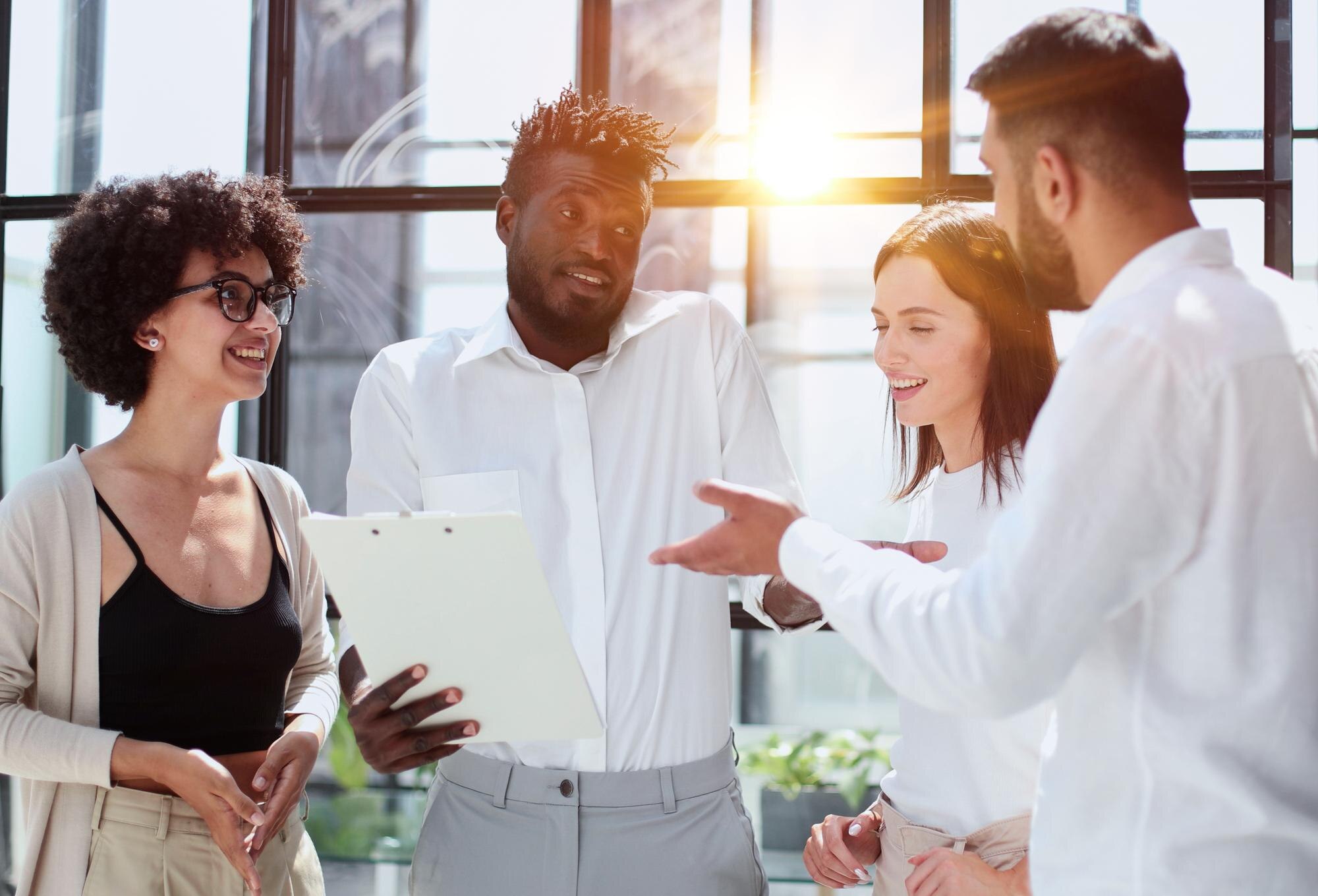 employees working at computer together discussing 86b09080d71209763046