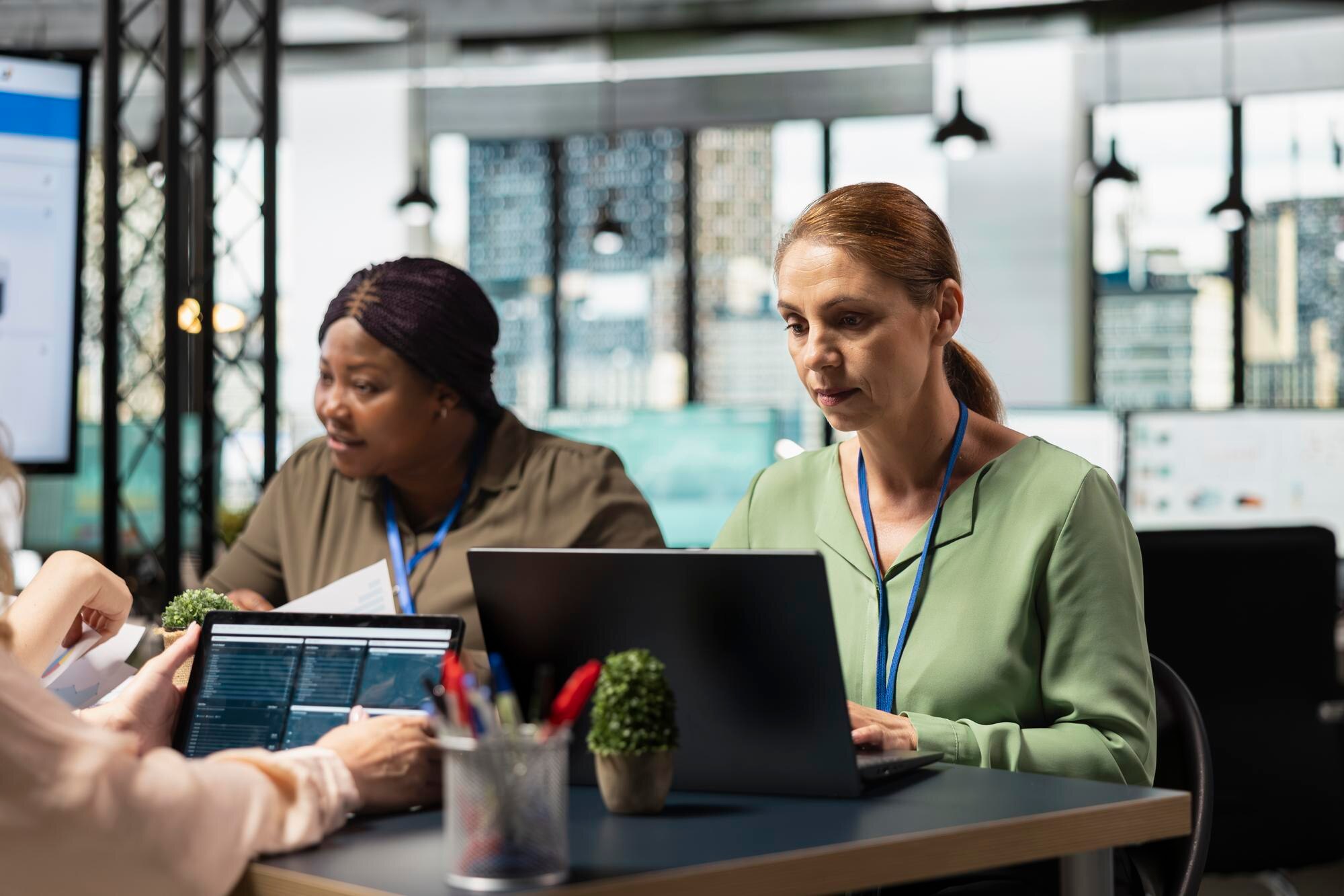 empowered team of diverse women utilizes laptop in 99247dedf0b8ab823f11