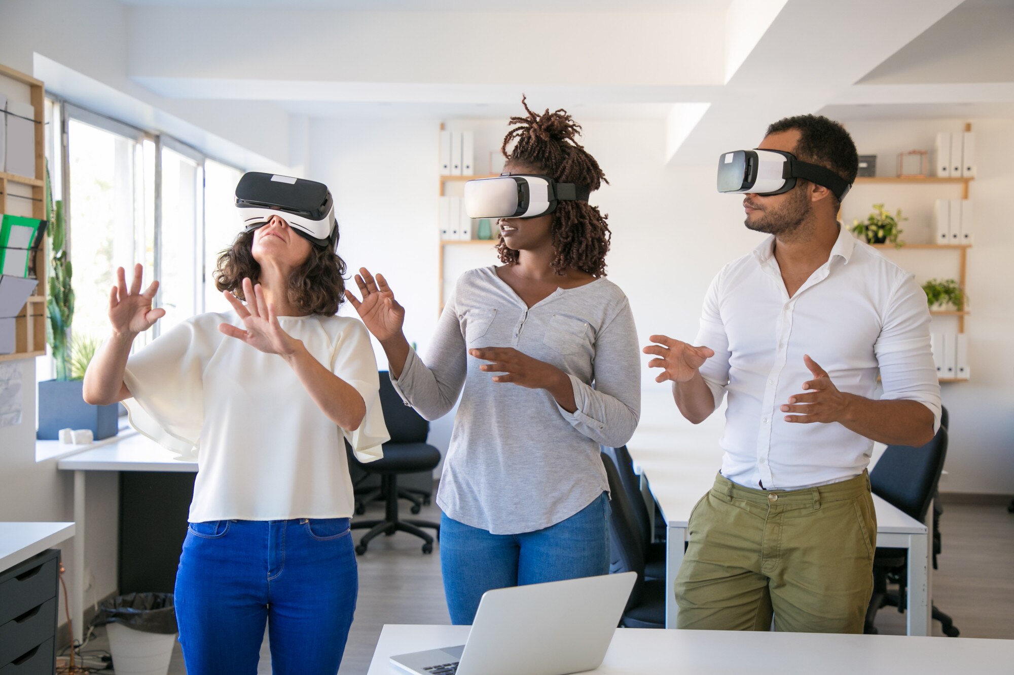 excited team of three testing vr simulator 3f86b6ba8eb227b0171c