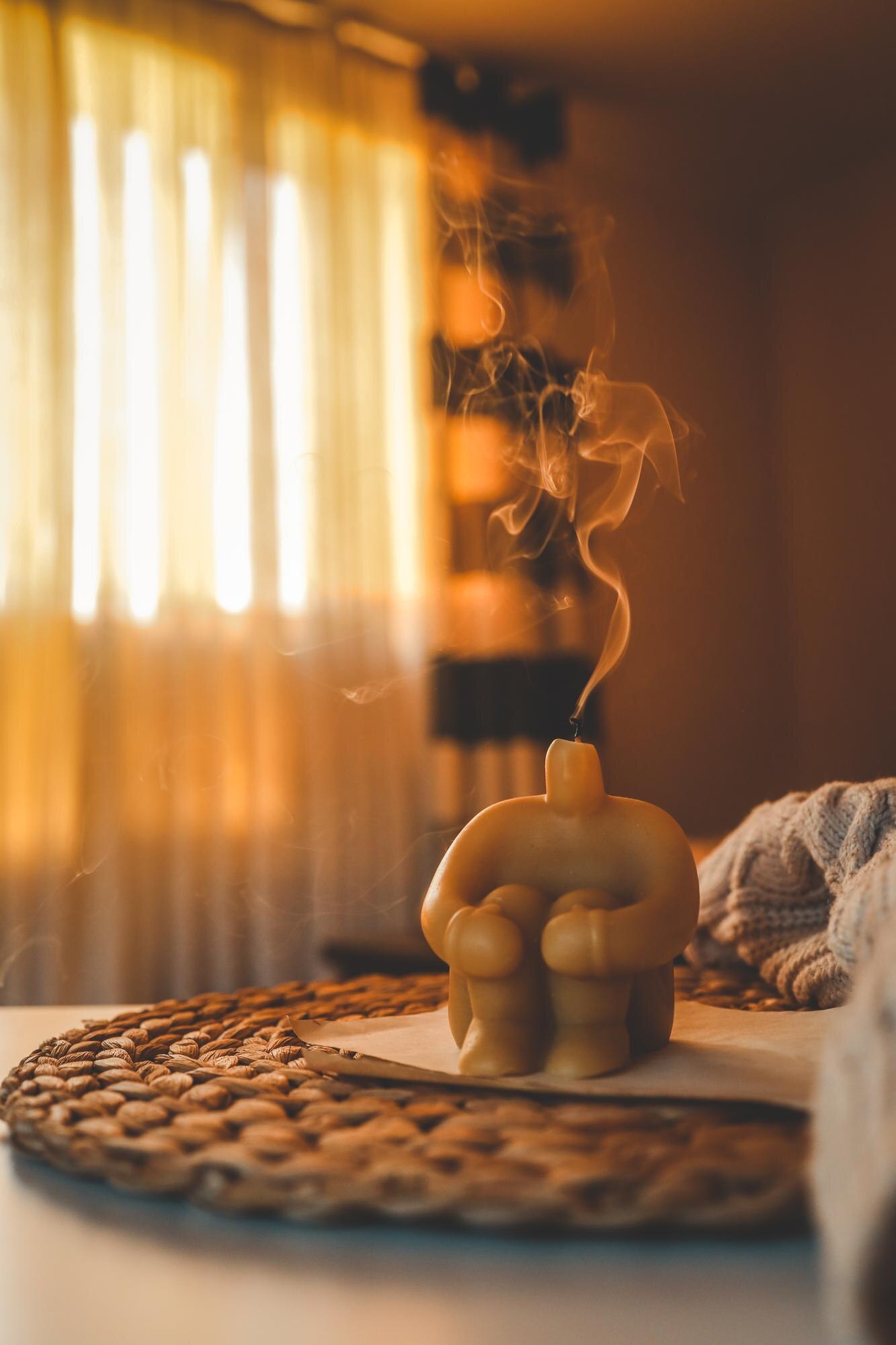 Meditation candle with calming aroma representing the combined benefits of meditation in a peaceful wellness setting.