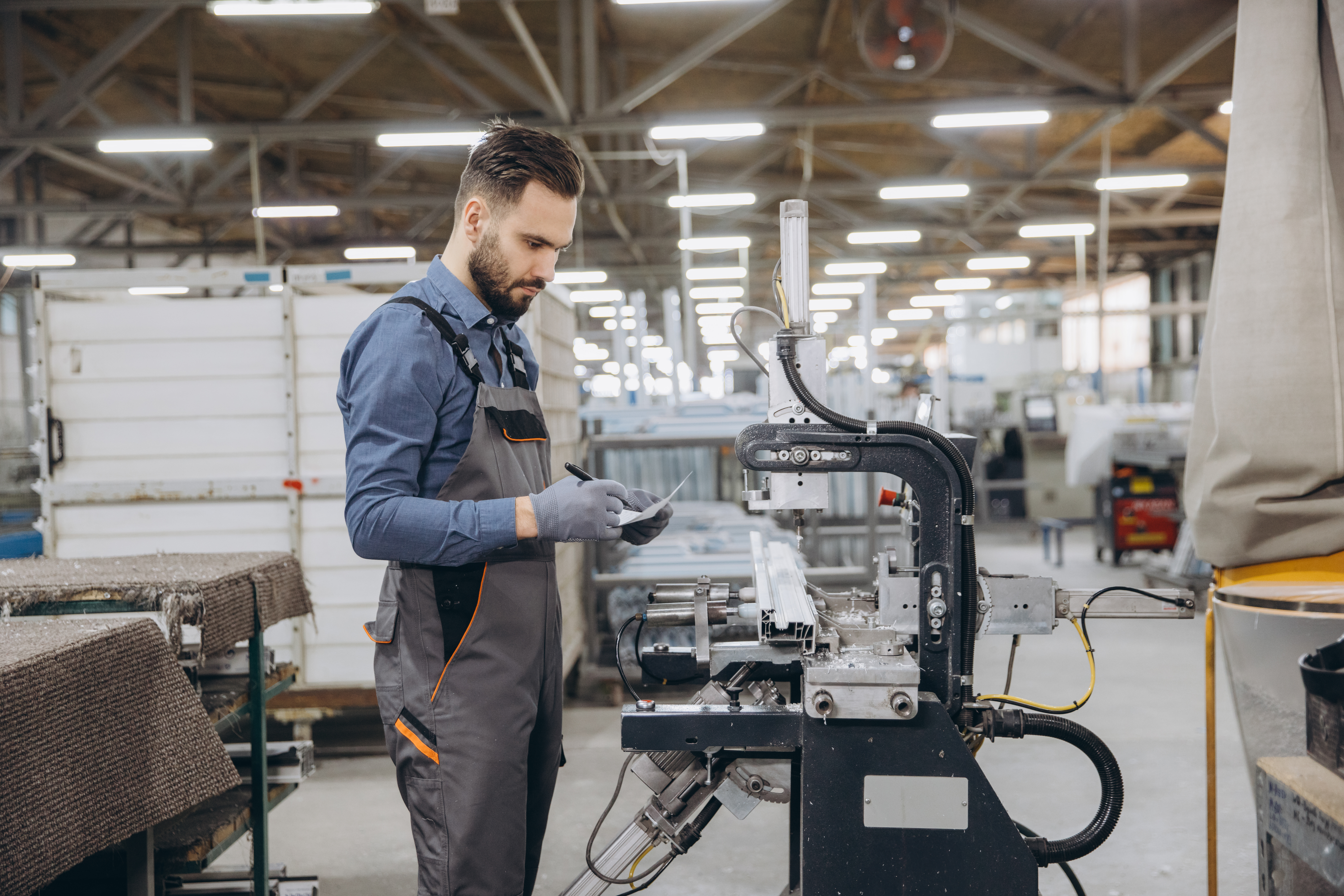 How precision fabrication cuts delays and cost blowouts in plastic projects 2 factory worker inspecting aluminum window profile 6db8f52b7cf5f1eb843e