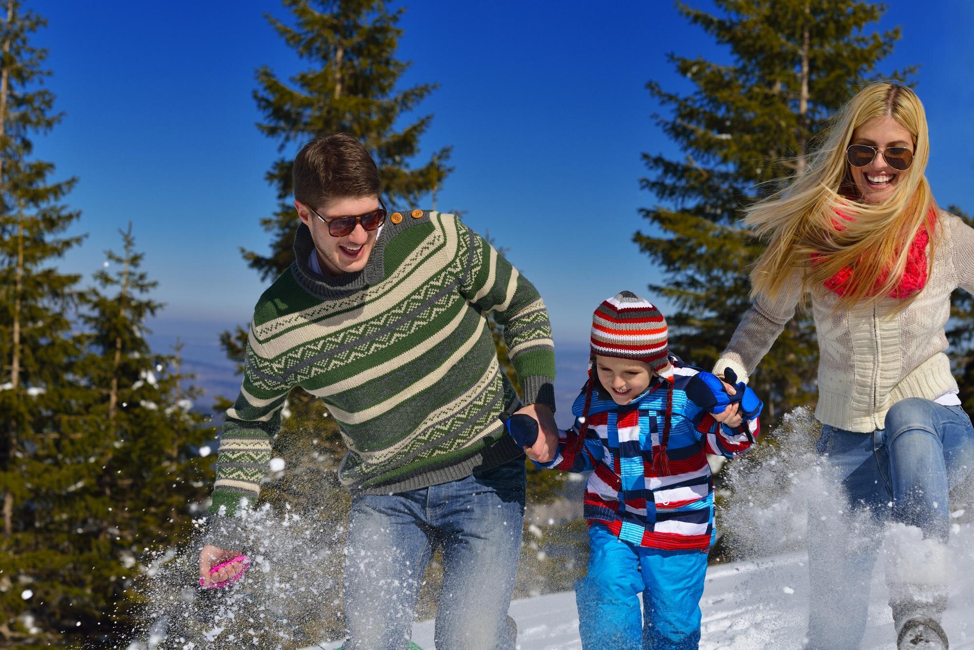 family having fun on fresh snow at winter vacation 33ab7162732fd4d1b191