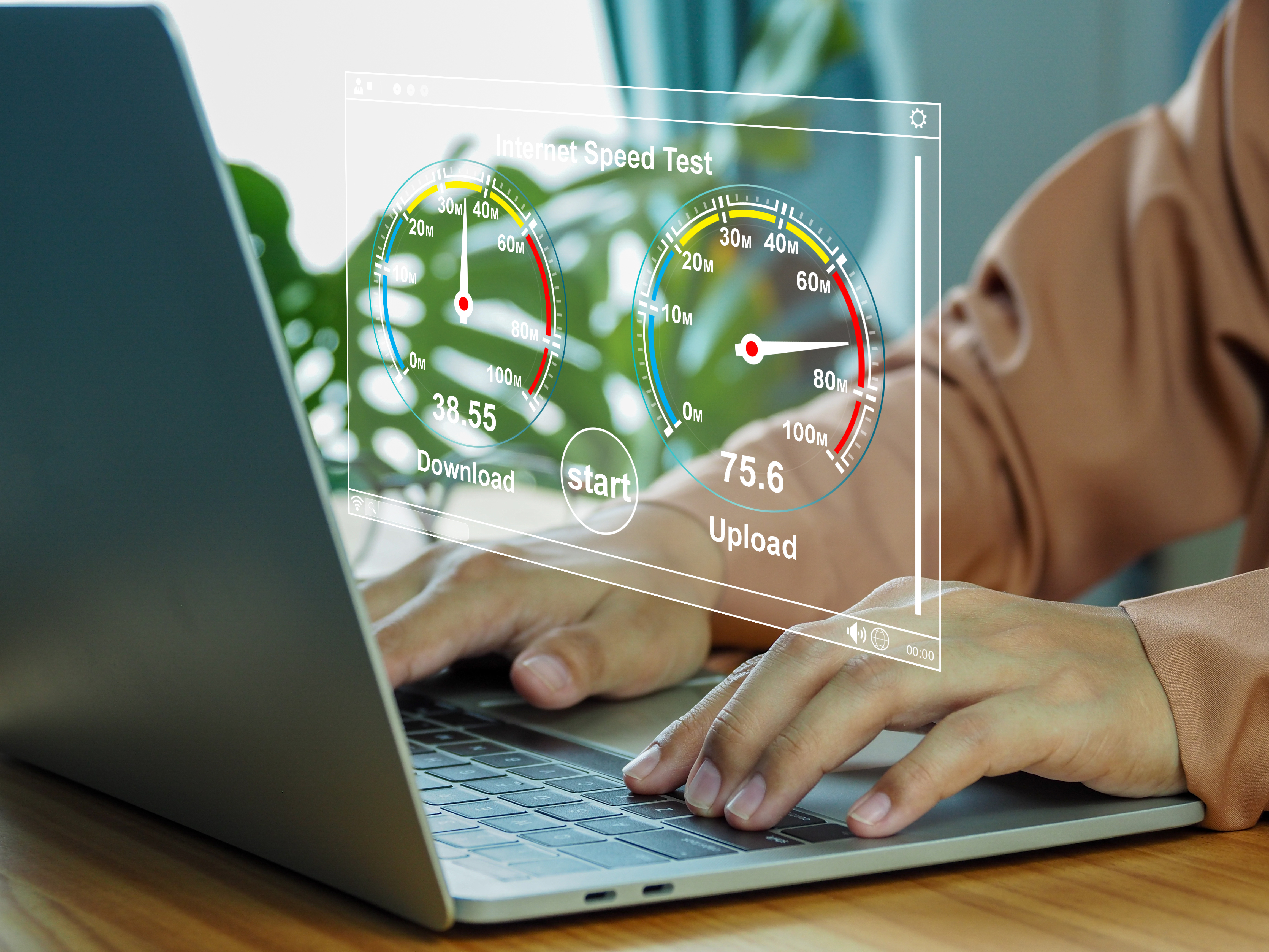 A person using a laptop with an internet speed test overlay showing download and upload metrics, illustrating how site speed impacts SEO performance.