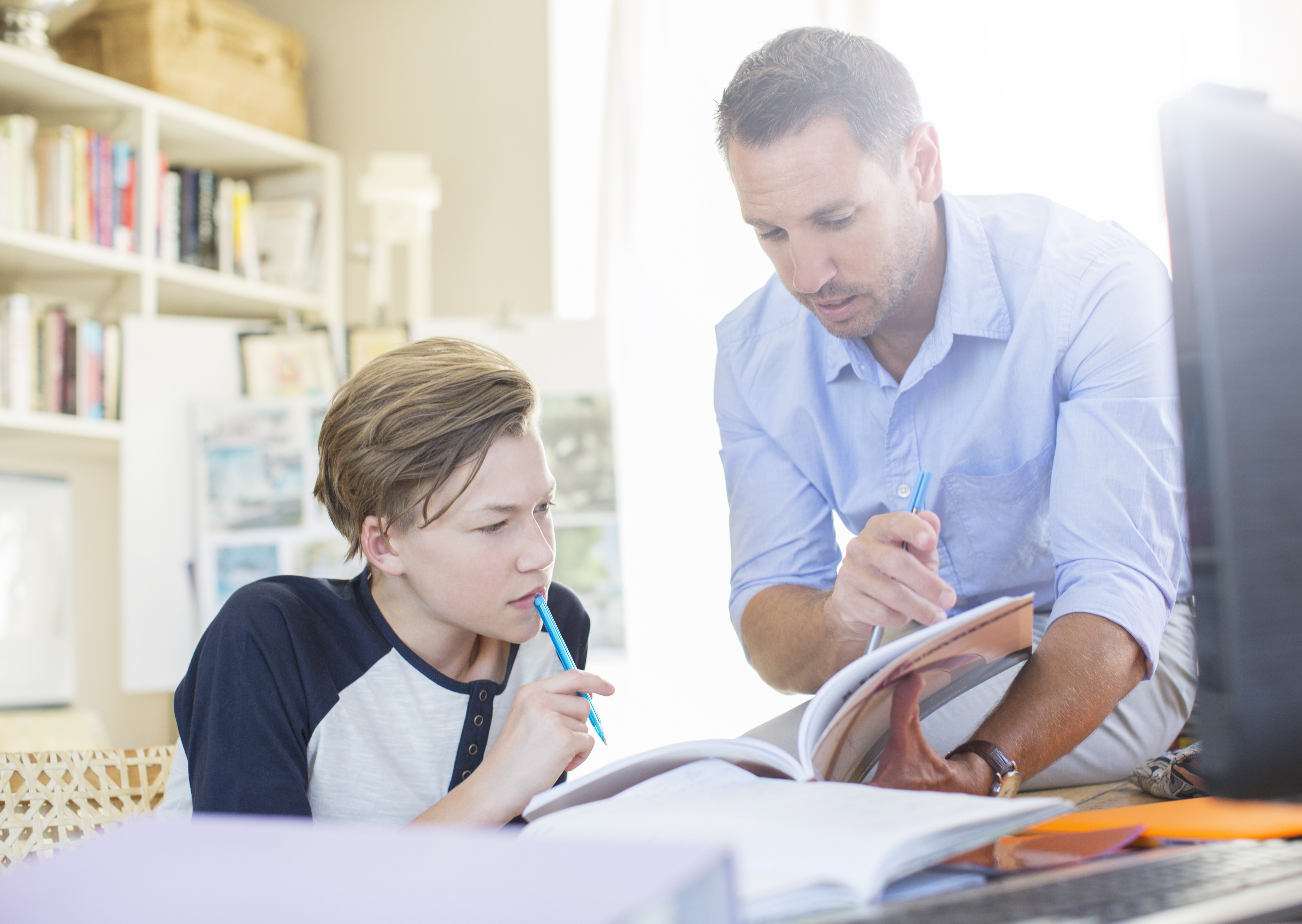 Father Helping Teenage Son With His Homework C381a7fa514814e3994b