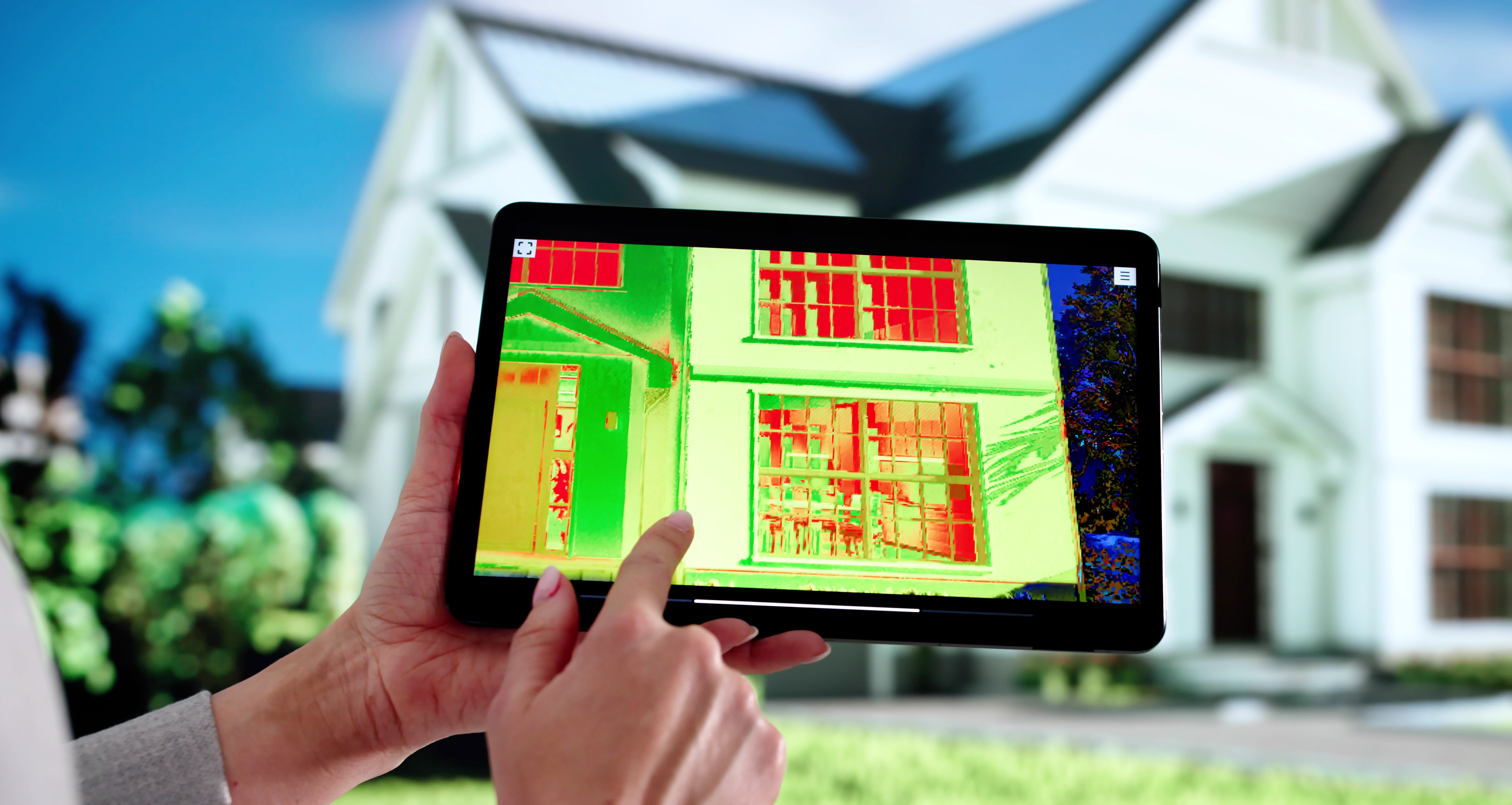 Inspector using thermal imaging on house