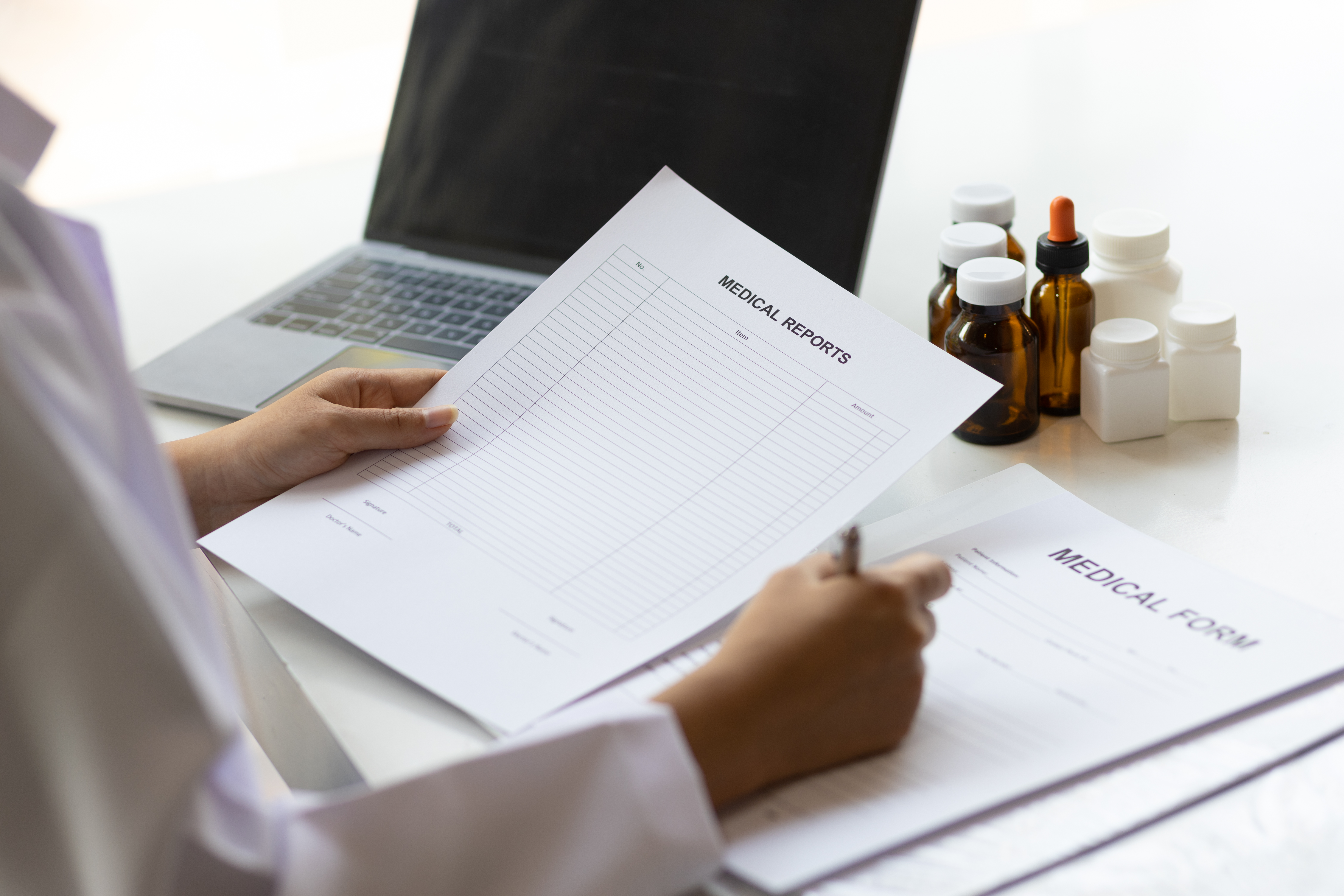 Mastering The Art Of Medical Writing For Oet Success 2 image of a medical professional reviwing medical report - illustrative image to describe OET medical writing courses by Accordemy®