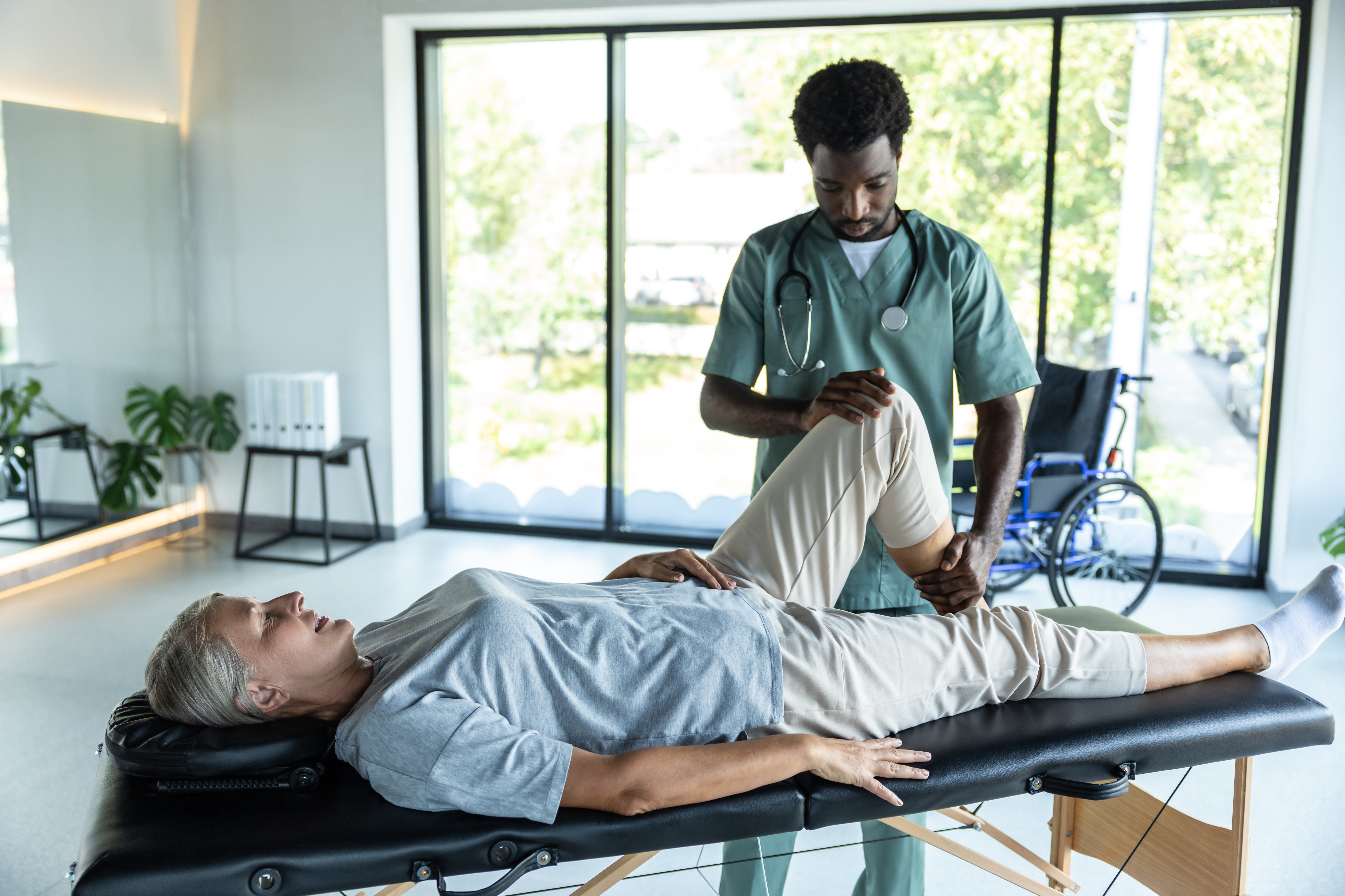 female patient lying on a couch while male doctor 81eaf0e91d004cacaf7e