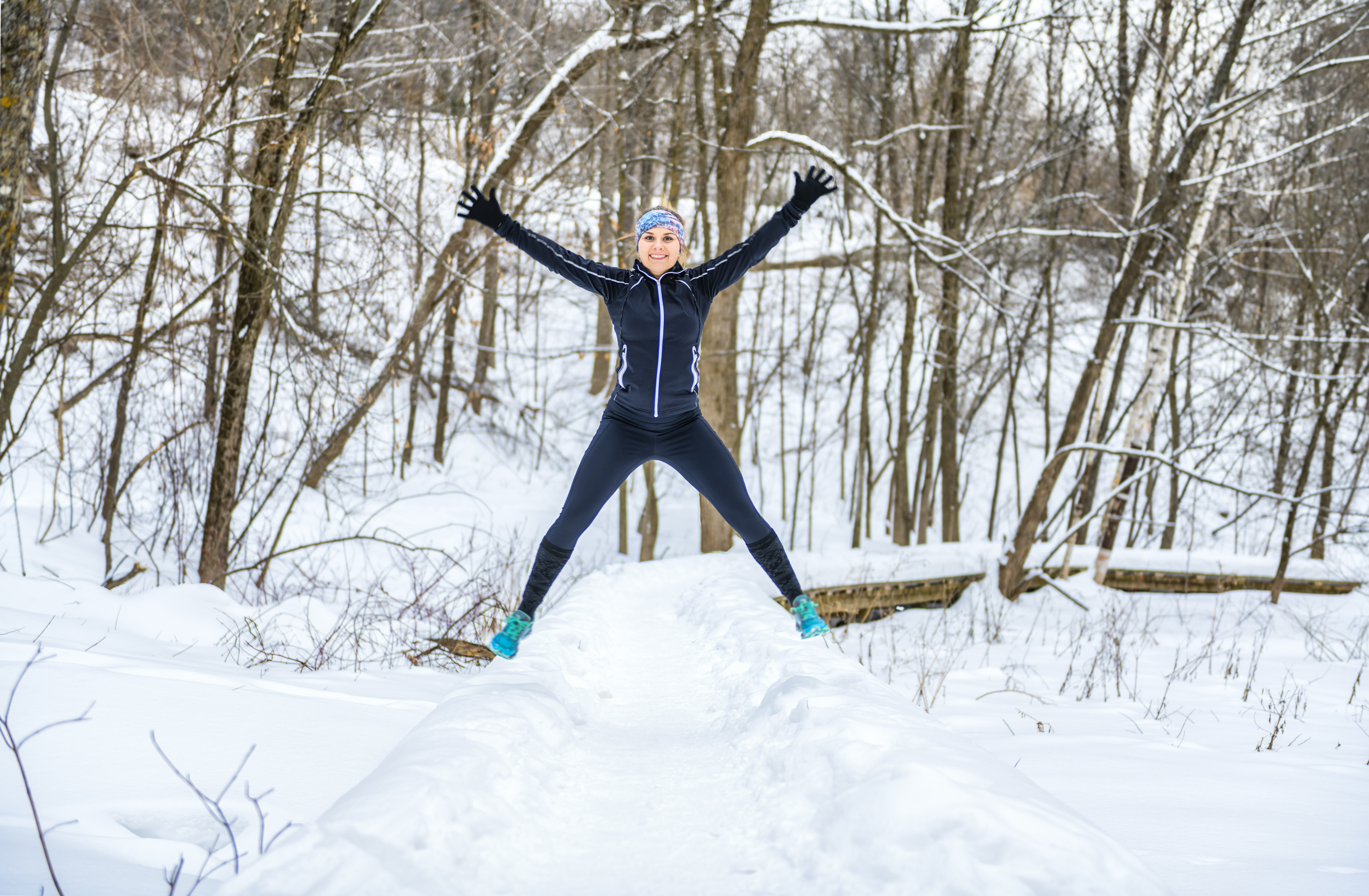 female runner jogging in cold winter forest wearin c6929eb3a979ebdeebed