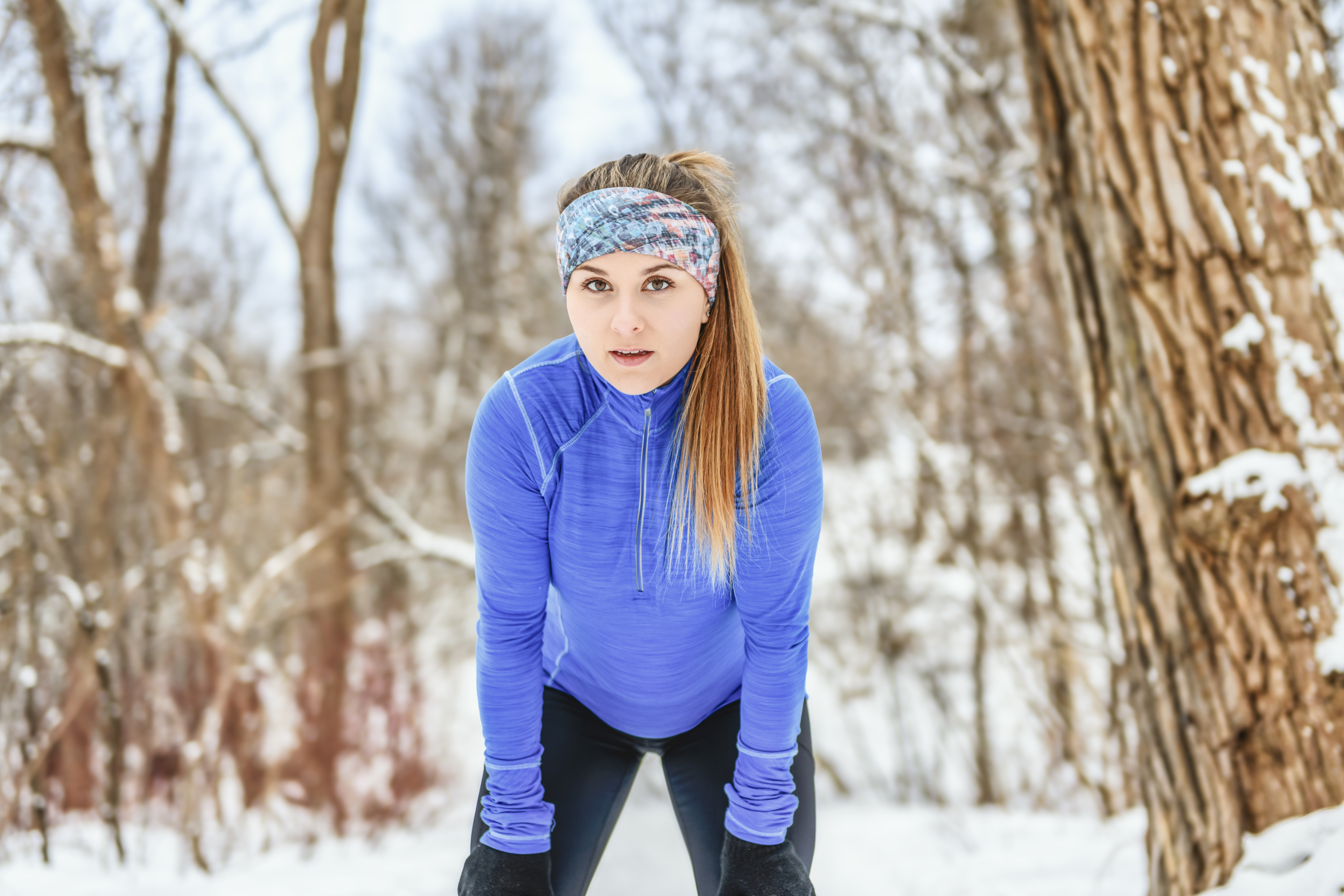 female runner jogging in cold winter forest wearin ebee2fdcf3e8cedcdbc9