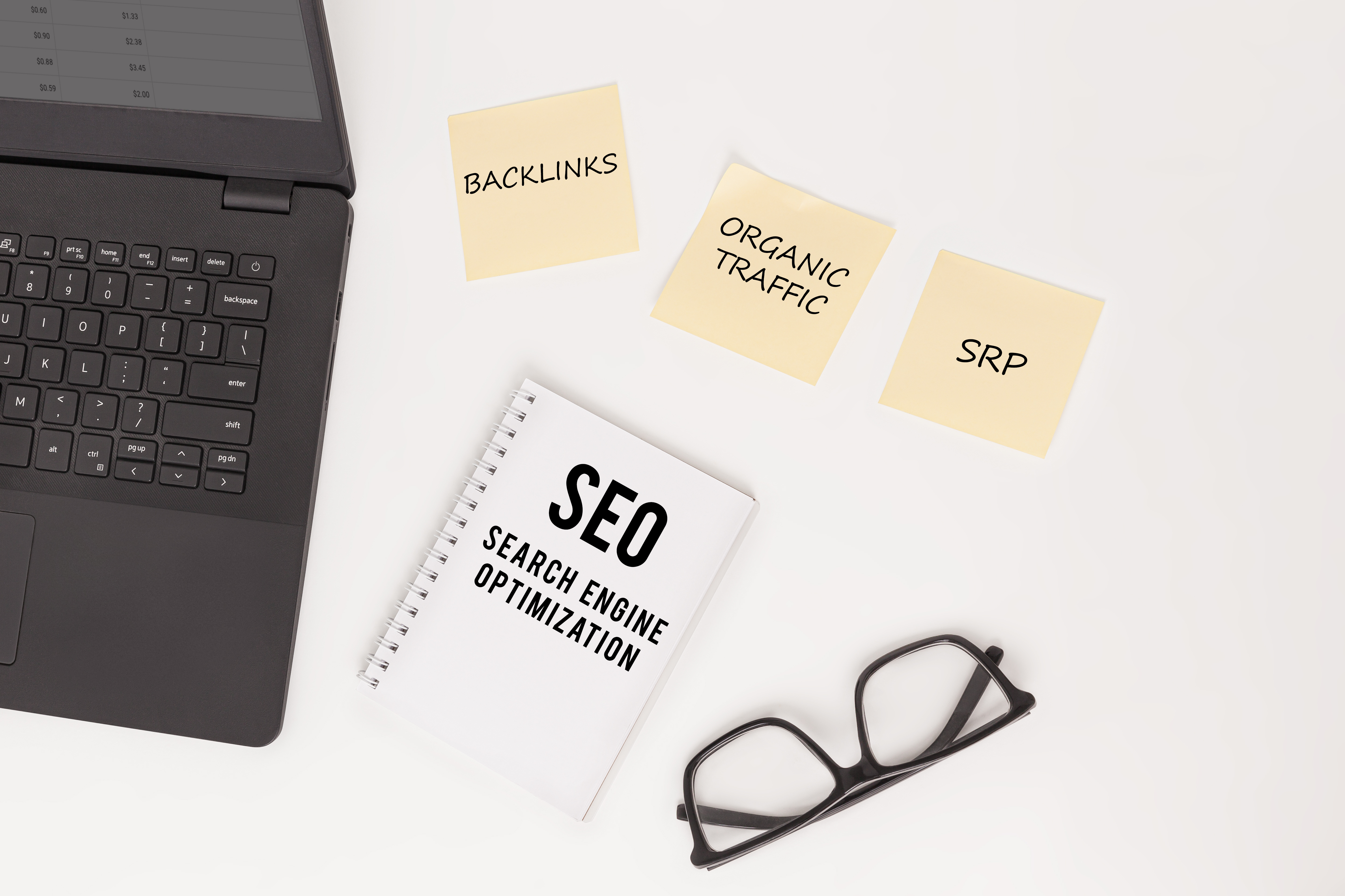 flat lay of a laptop glasses notebook labeled s b9344a01c55f7739ac81