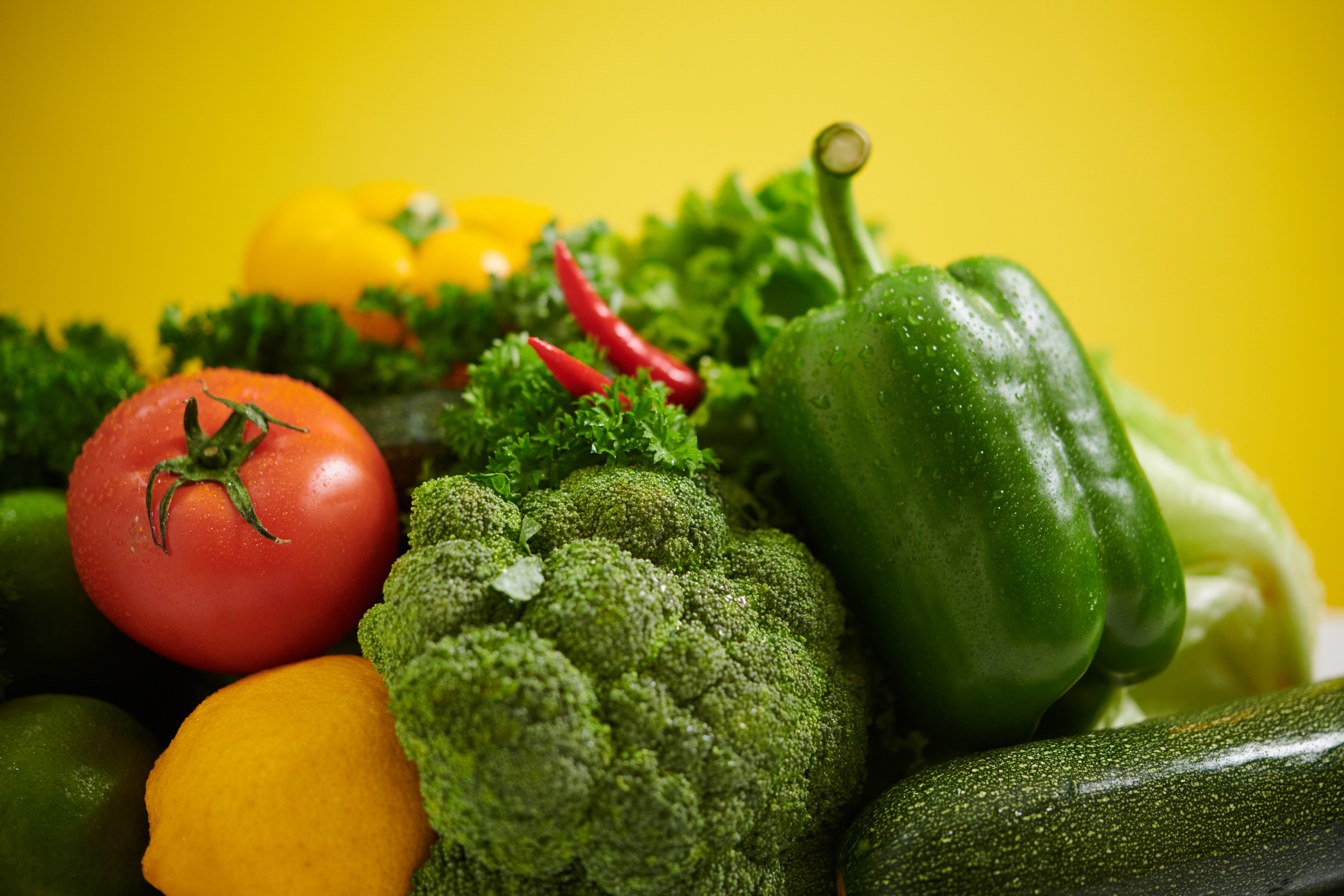 fresh vegetables display on yellow background 0e106692d28970e519f7