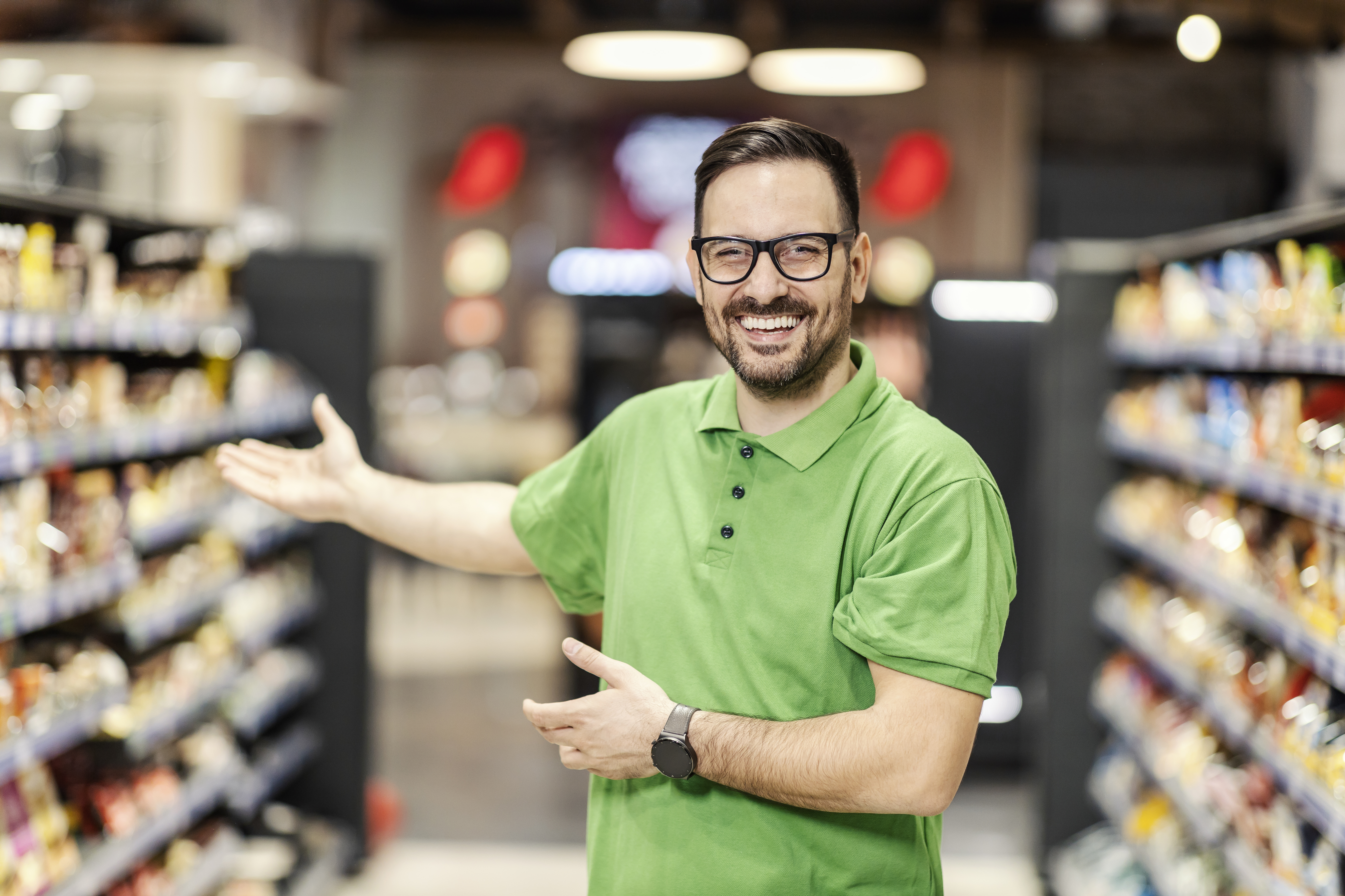 friendly employee welcoming customers in supermark 55c7bfb89e631c9dfaa5