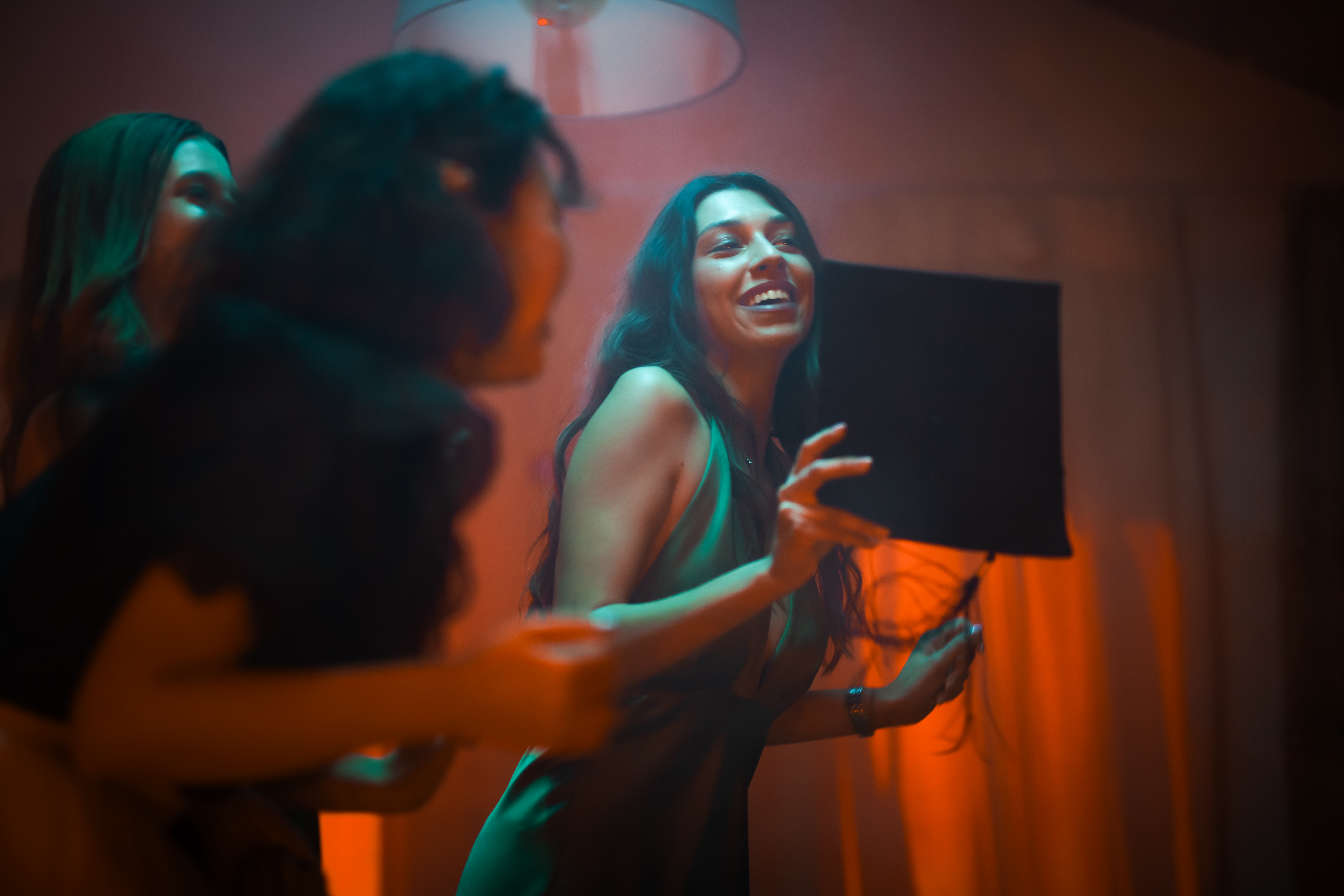 Capturing Unforgettable Moments: The Magic of Interactive Photo Booths 2 friends celebrating joyfully illuminated by warm l 54e5950161ba9fec8ec2