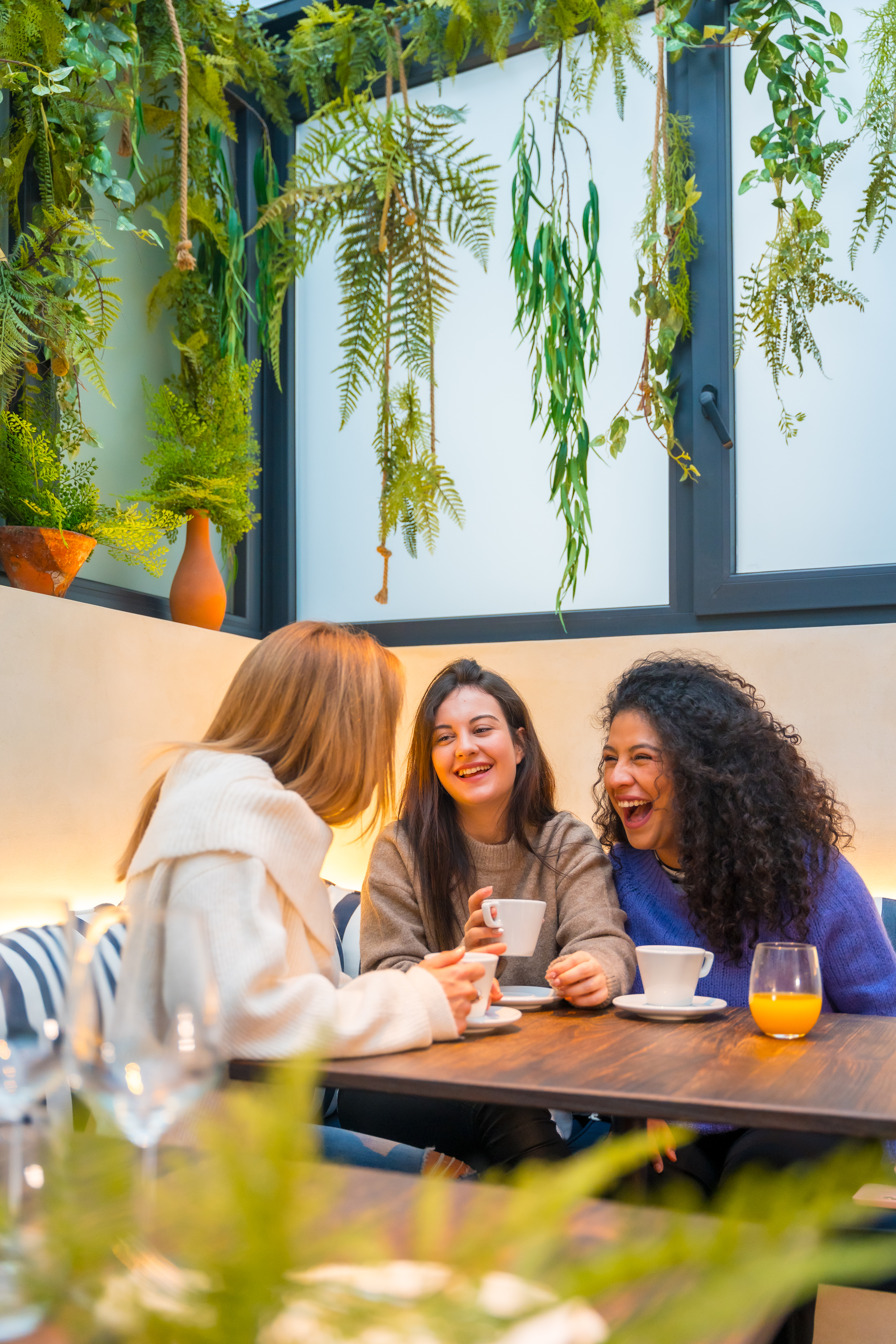 How to Build Your Travel Tribe from Scratch: A Guide for Aspiring Wanderpreneurs 3 friends having fun laughing in a cafeteria 16bf649f1532e1ad8722