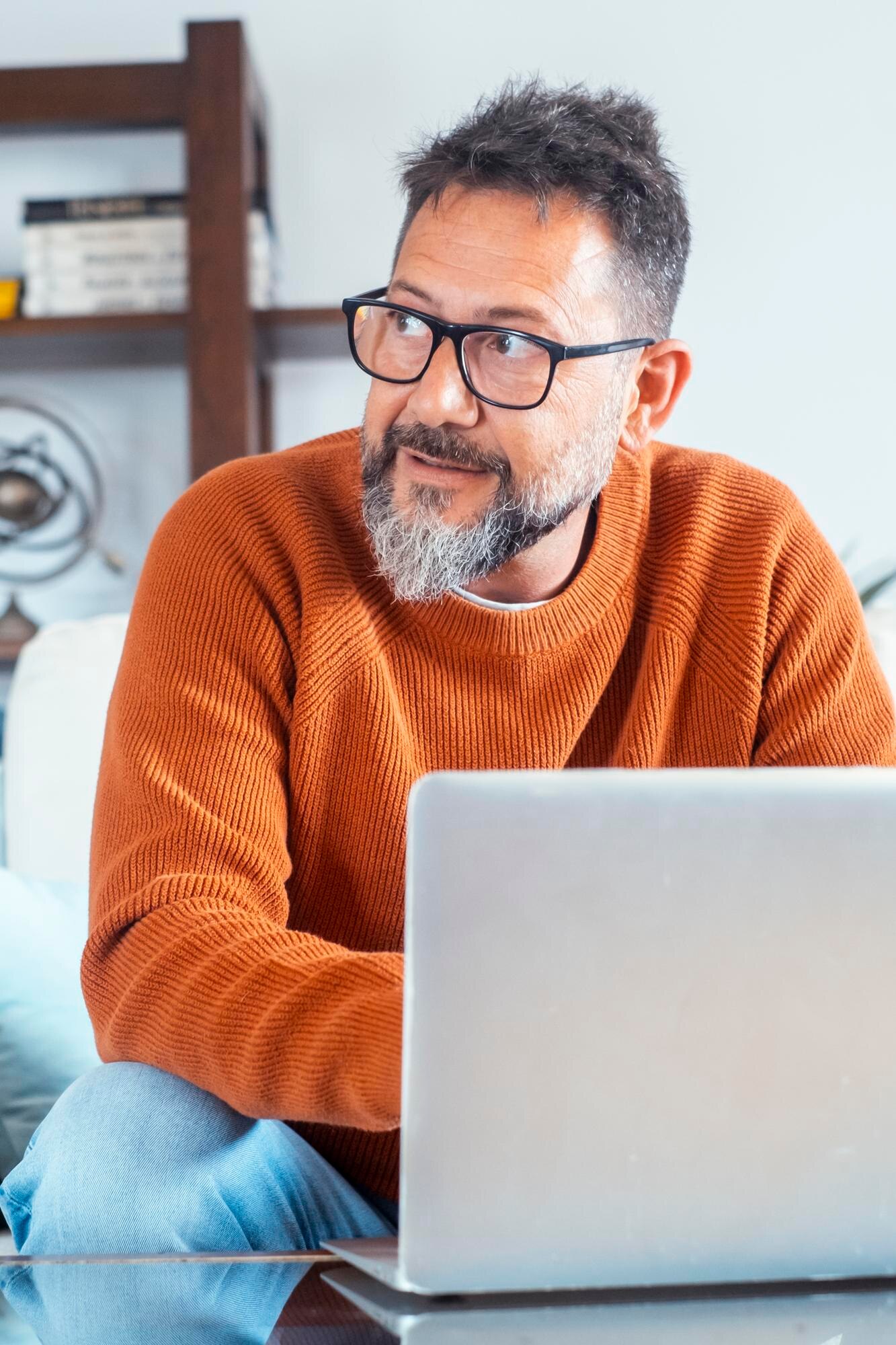 front view of adult man working on laptop at home a22dbd548bfd6bace426