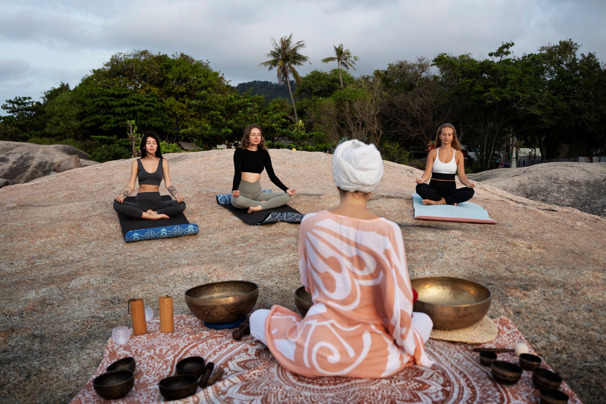 full shot woman with singing bowls outside de579ef26e56fca80800