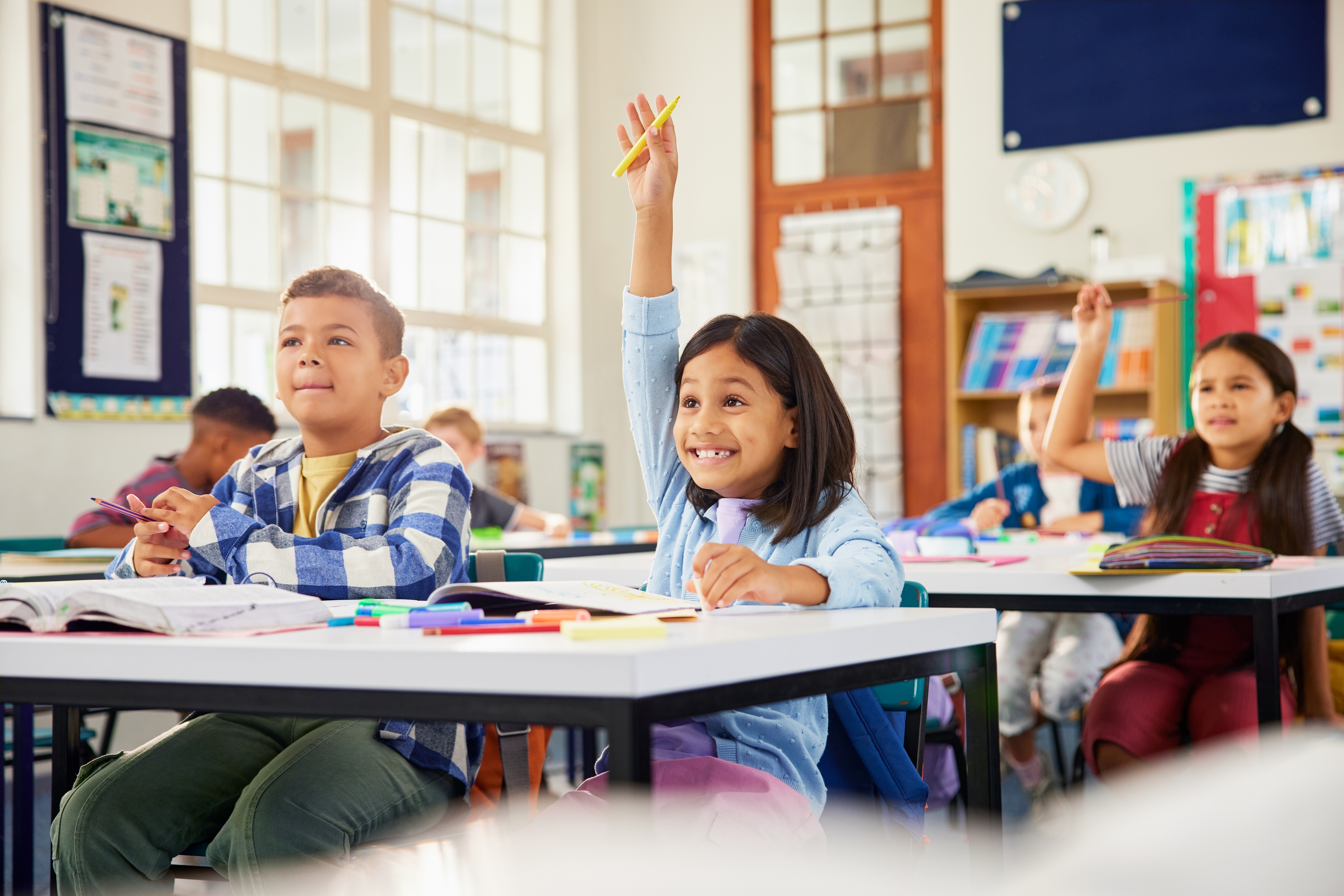 girl raising hand in classroom she knows the answ 25afe48d8fc5f32b84cf