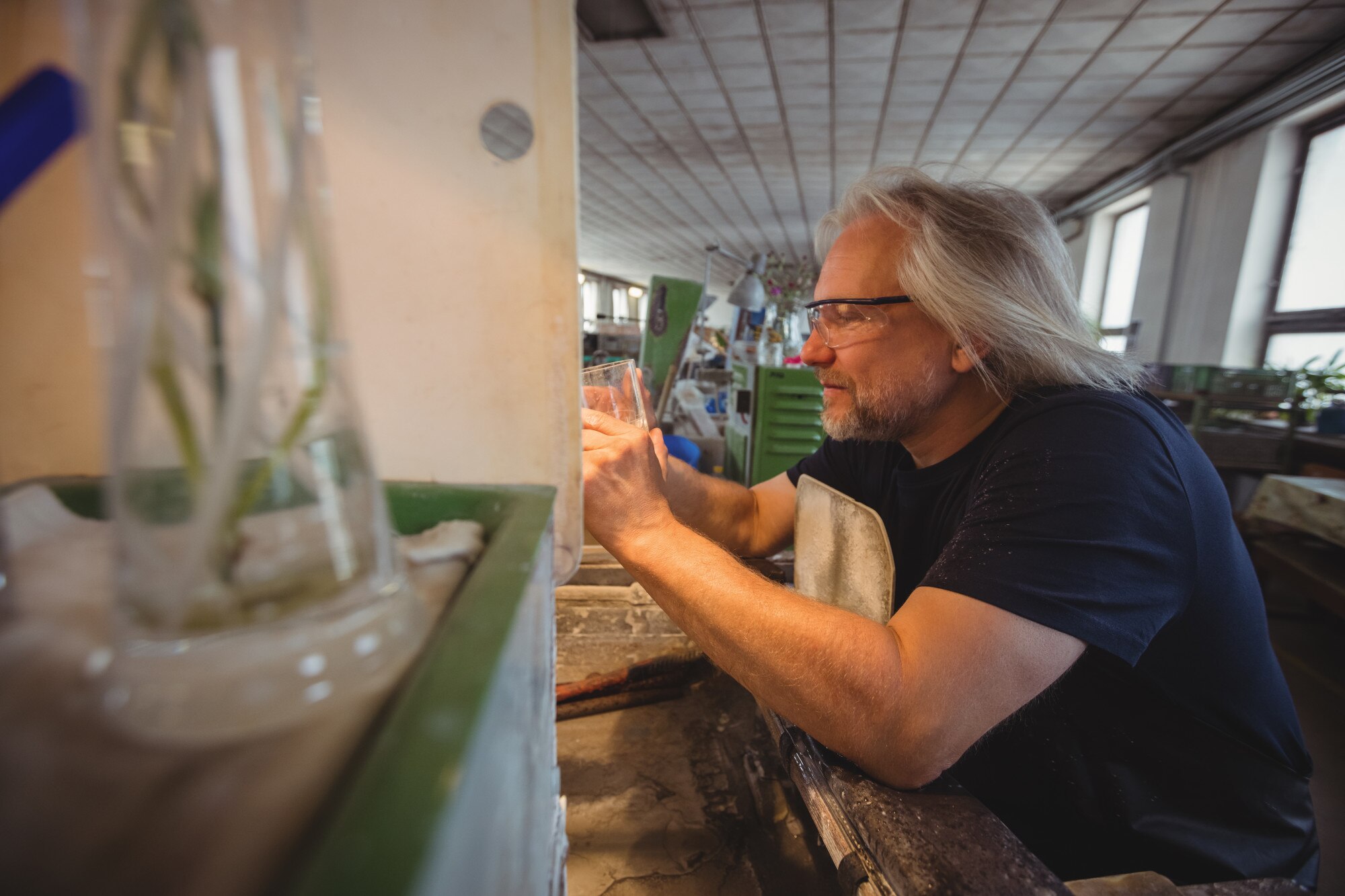 How Local Plastic Fabrication Supports Sustainable Practices in Australia 1 glassblower polishing and grinding a glassware 6c3764955a8d4cb524ce