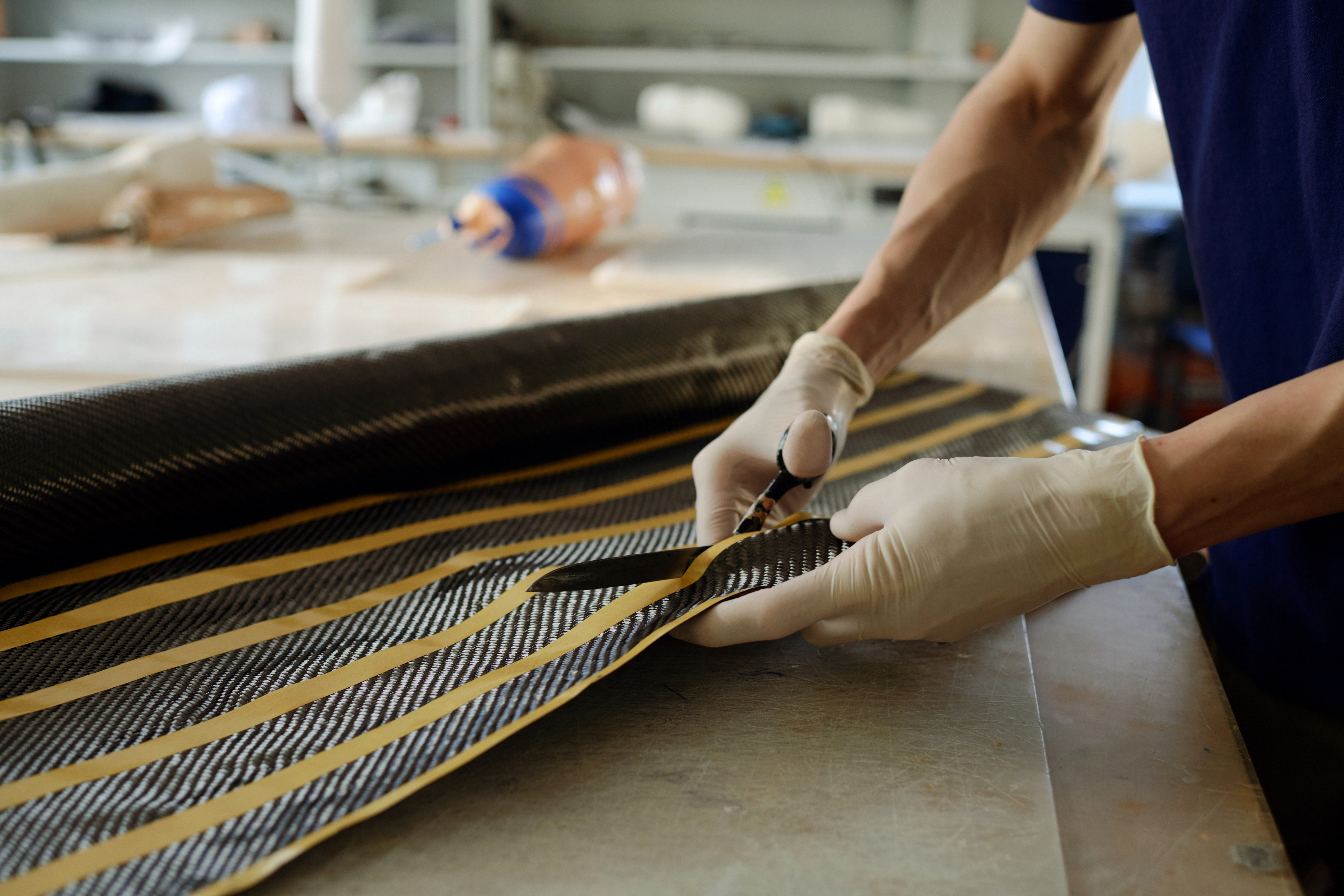 Tailored Cut‑to‑Size Plastic Solutions: What Every Trade Professional Must Know 2 gloved hands of young manufactory worker cutting s 13ae9bd8a7d64ddb6f7b