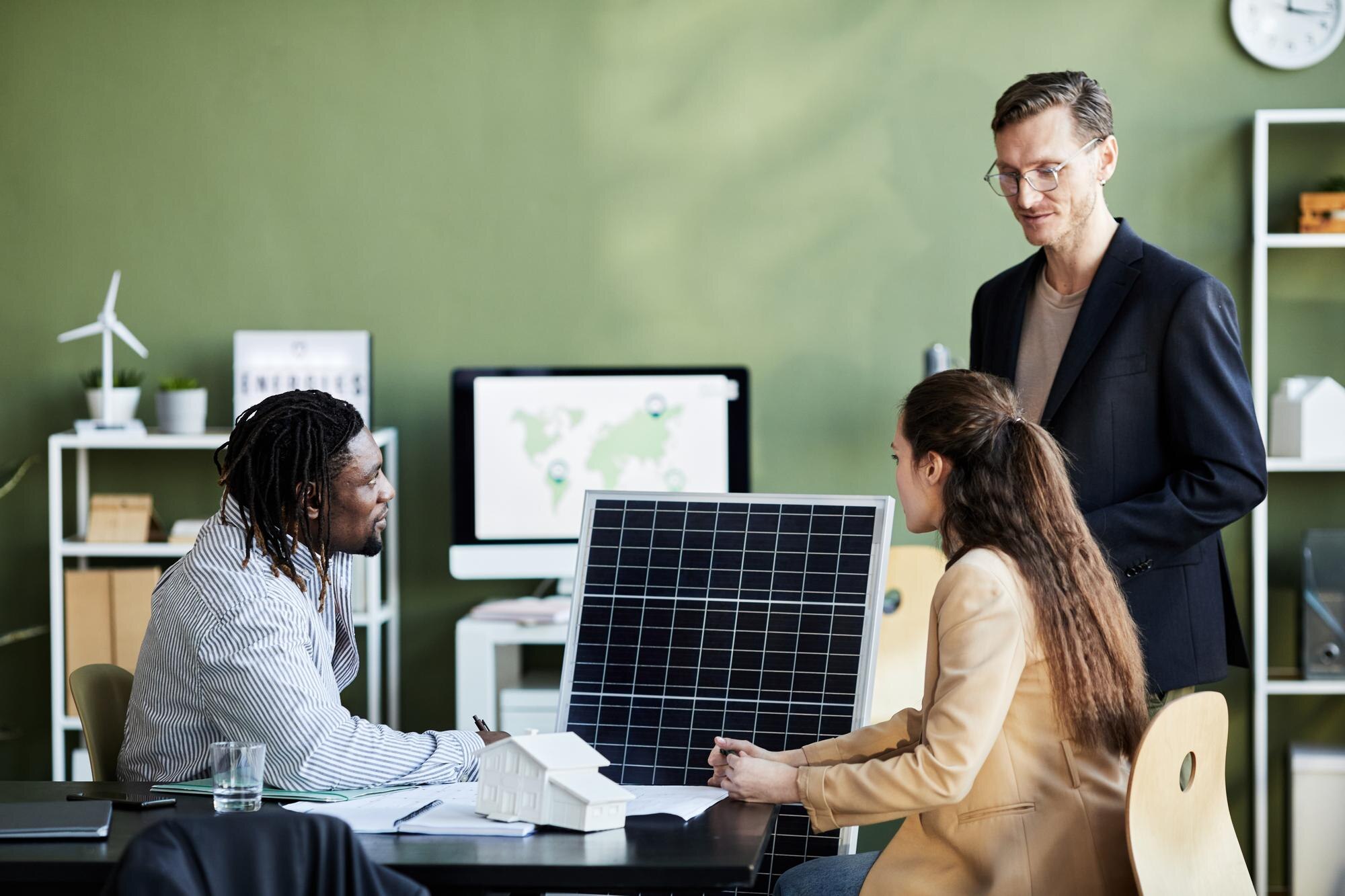group of business people developing solar panel fo 4e7aa5628ac4958f8991