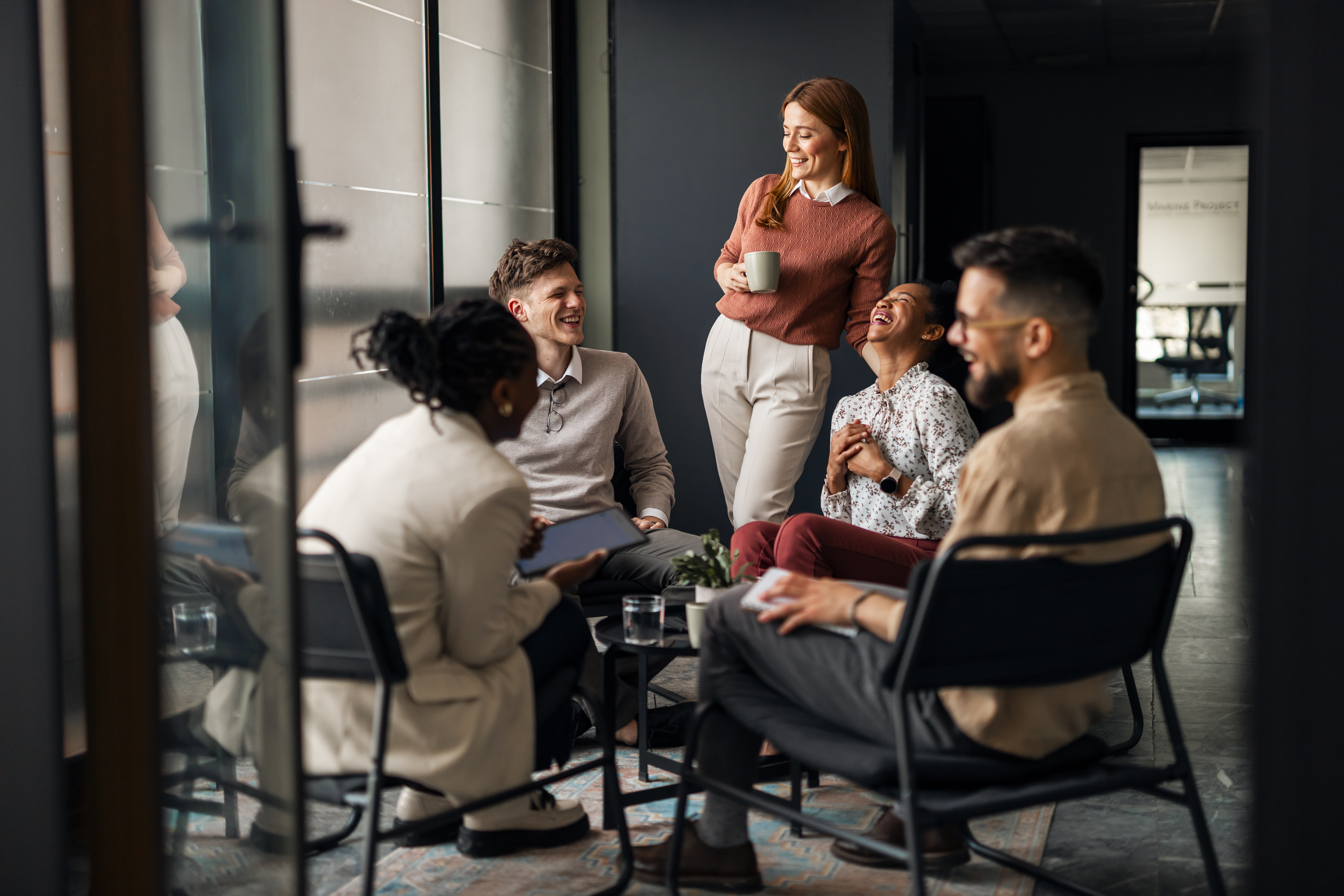 Building A Community Of Realistic Personal Development Advocates: Join The Revolution 3 Group Of Colleagues Sharing A Laugh During An Info 38E2Aad1De7Efffada04