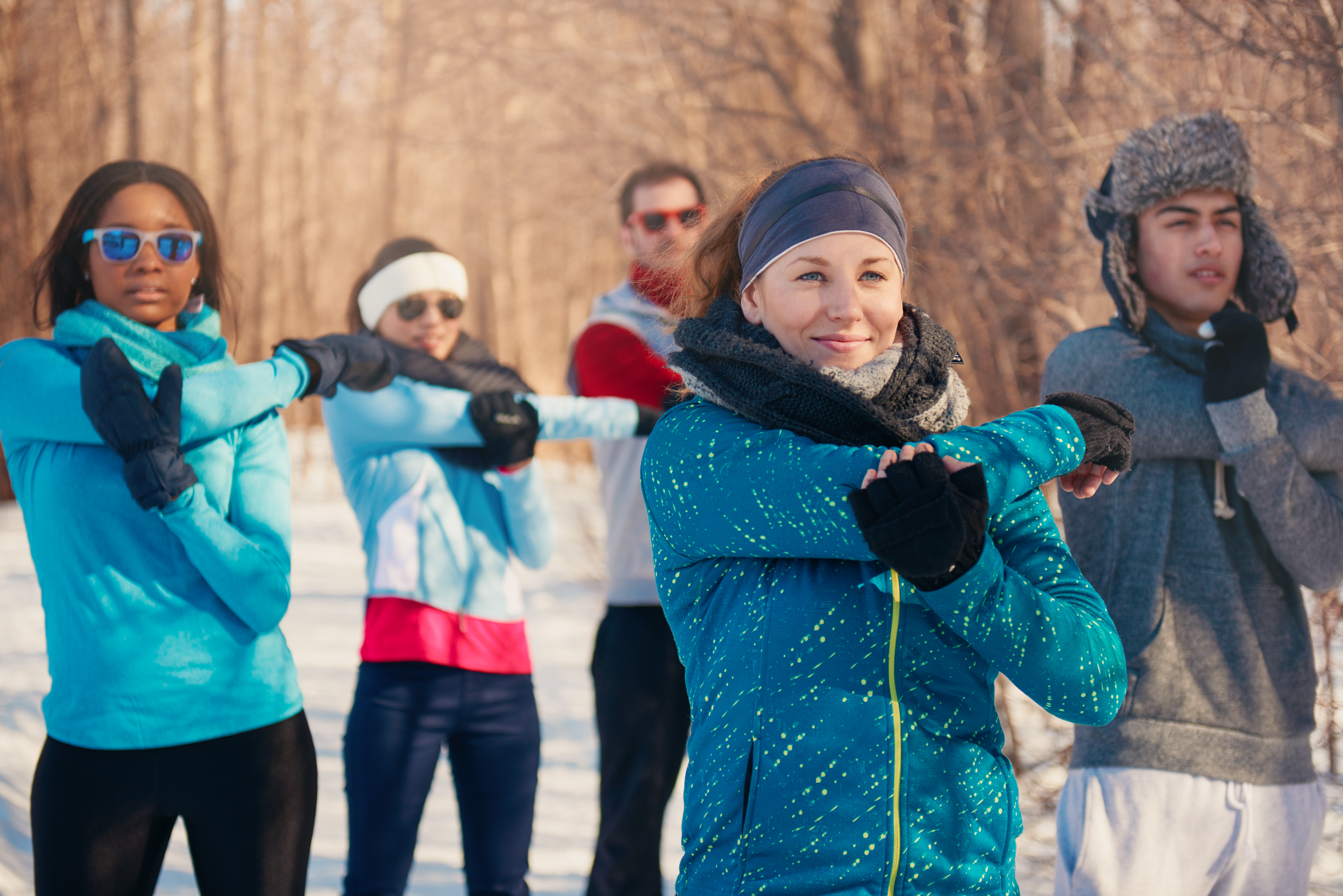 group of friends stretching in the snow in winter b3e0f6edb894c64cb1f8