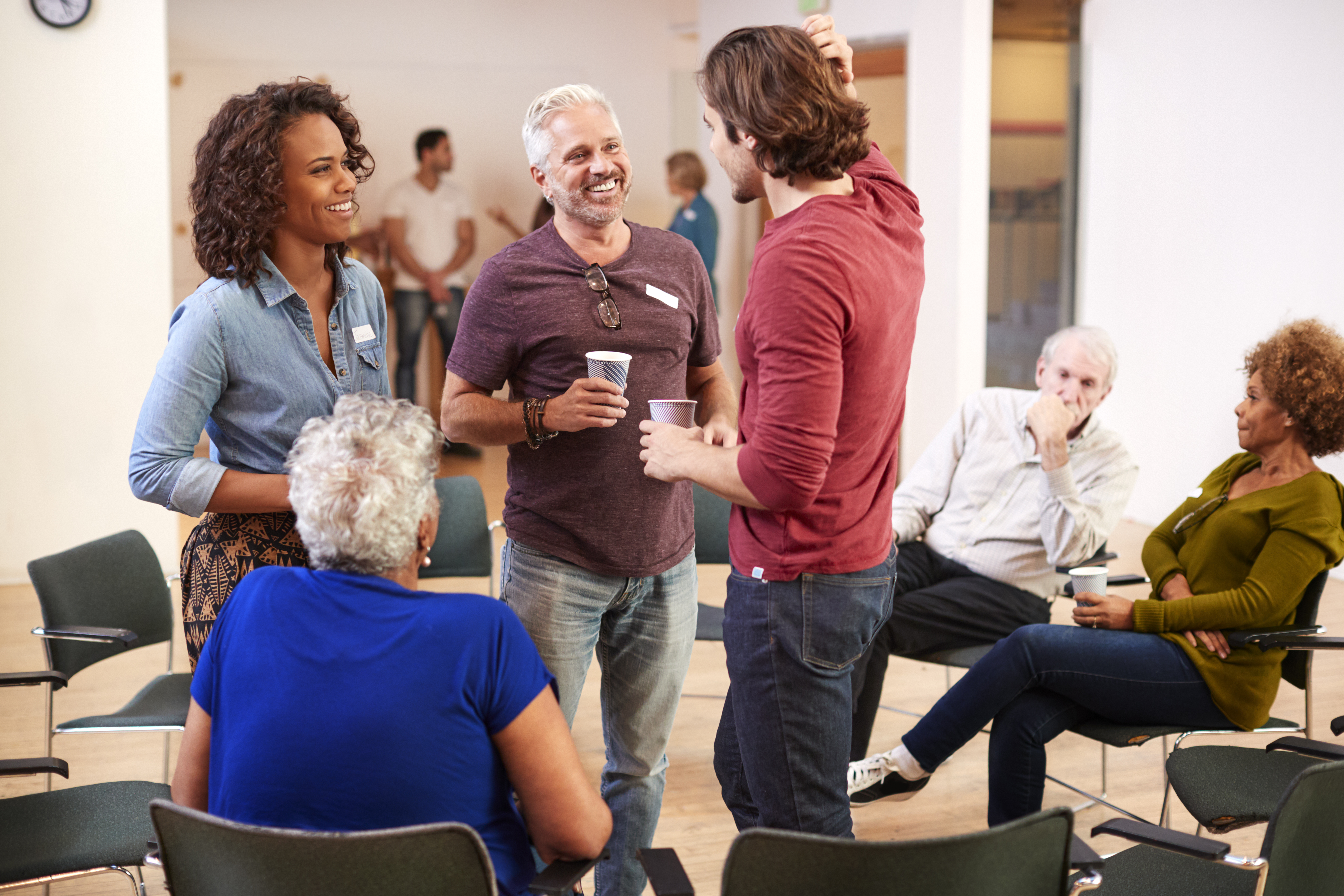 group of people socializing after meeting in commu ee43231378a686db9cfc
