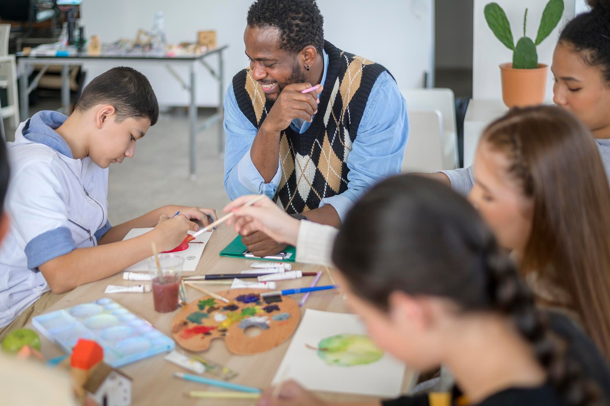 group of students studying and playing with teache 7f3bea948acad5031769