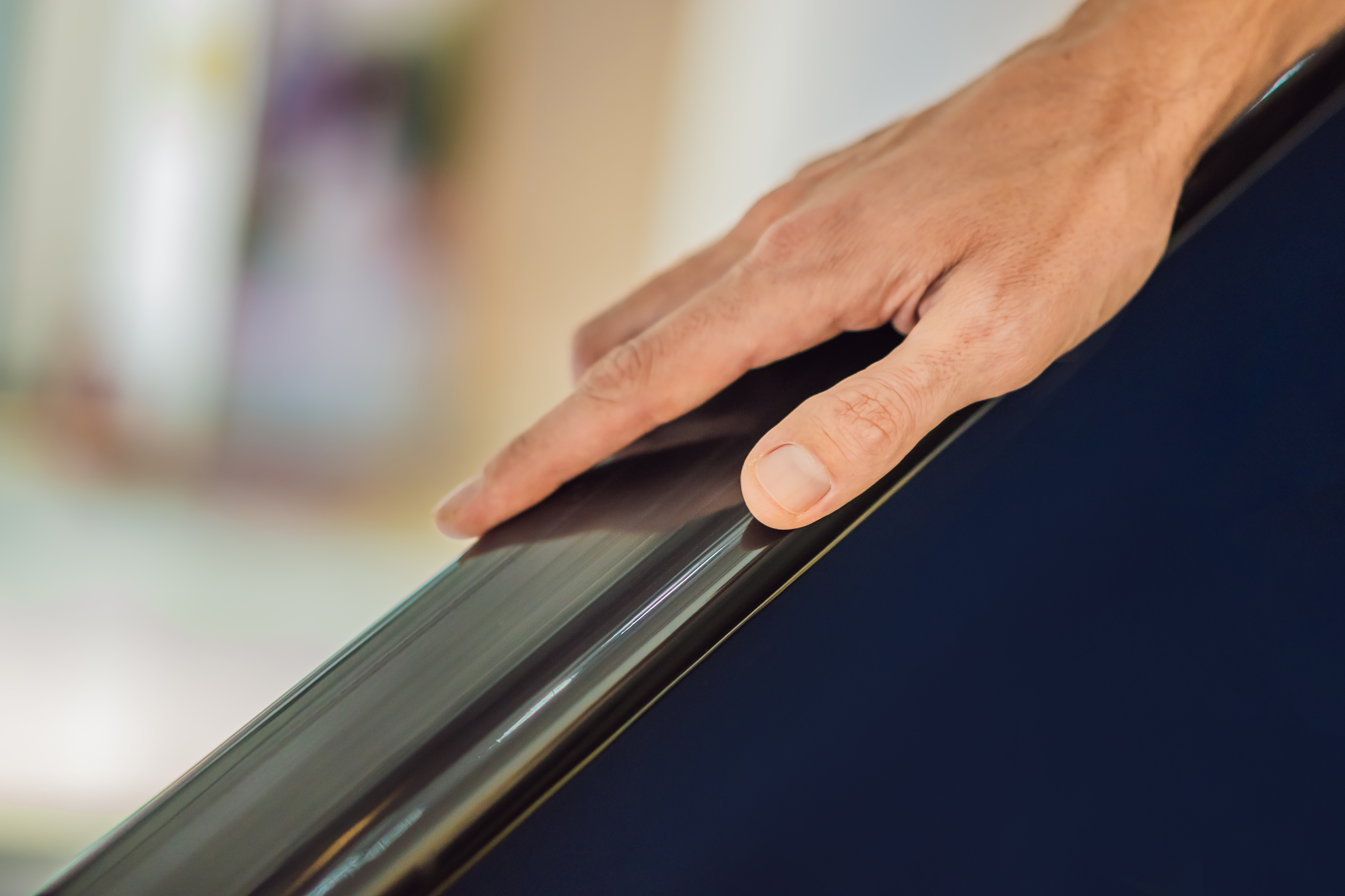 How award-winning plastic fabrication boosts reliability and customer satisfaction 3 hand is holding the escalator blur background 2e9395884c5280abaaff