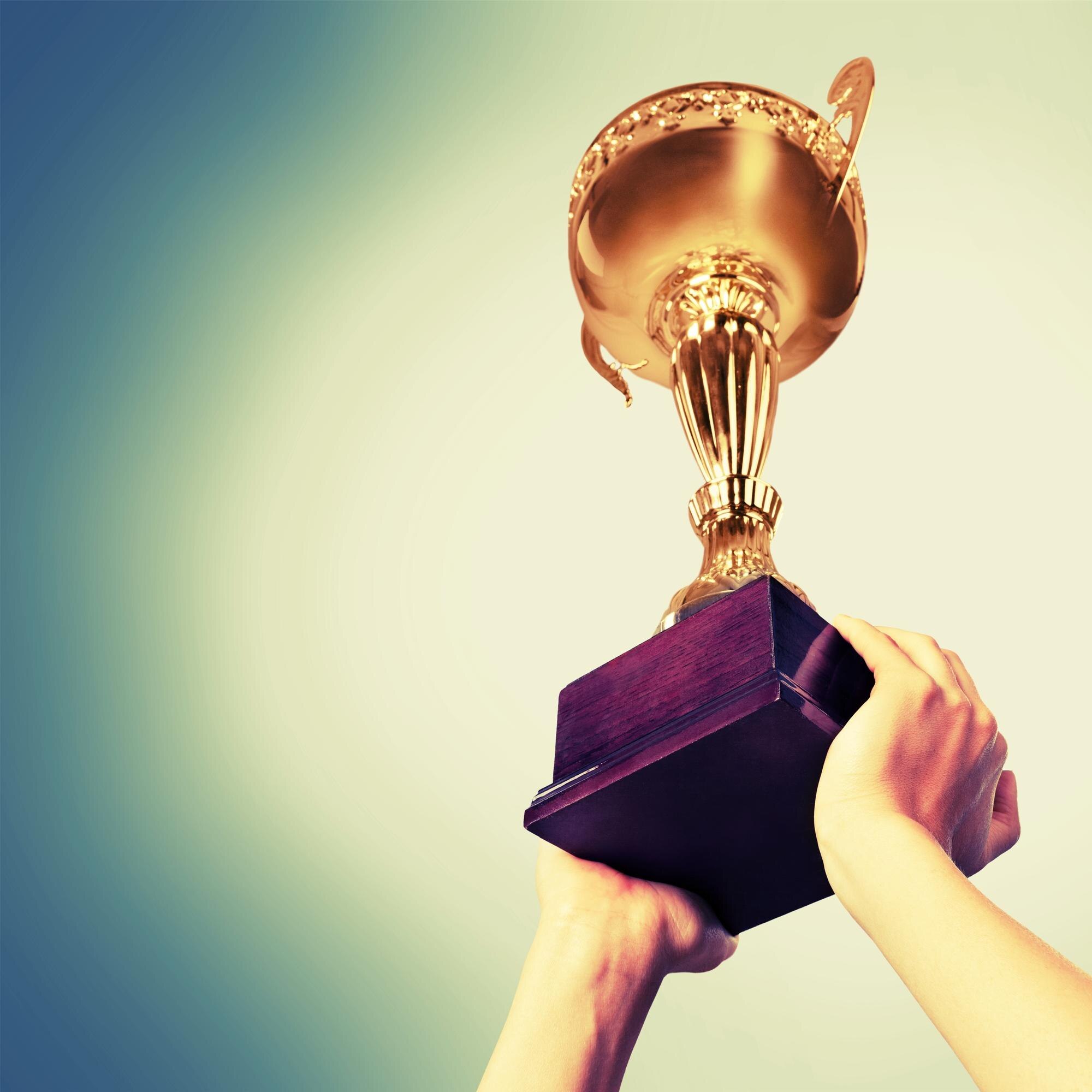 Why Australian Businesses Trust Local Plastic Suppliers with Award‑Winning Service 3 hands holding golden trophy on a white background 6a1f33ba6580a232128e