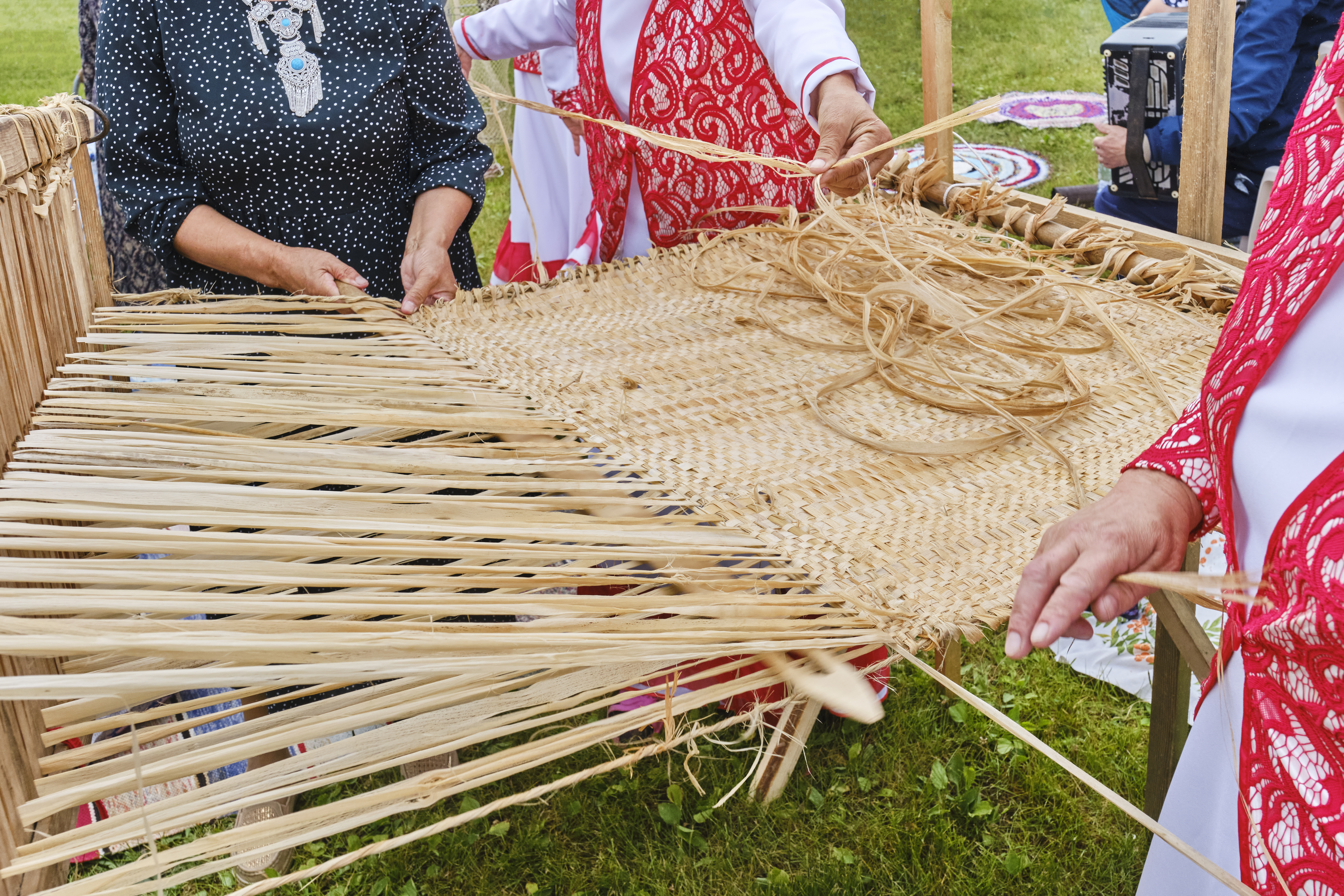 hands of senior women weave bast cloth on wooden l 07c35d7af80c79962b1b