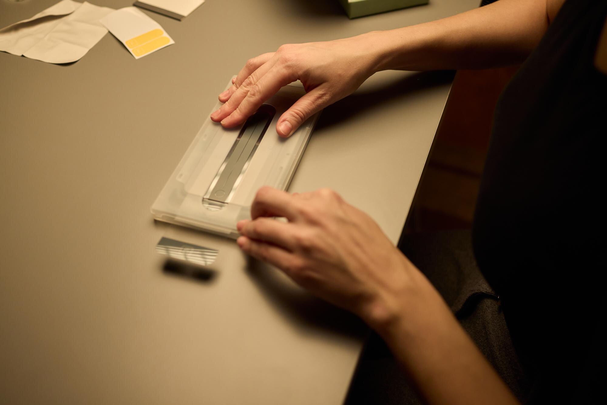 How to Order Custom Cut-to-Size Plastic Sheets Online: A Step-by-Step Aussie Guide 3 hands placing an object on a table in a softly dim e97a4b8b90ebdbbe9d7e