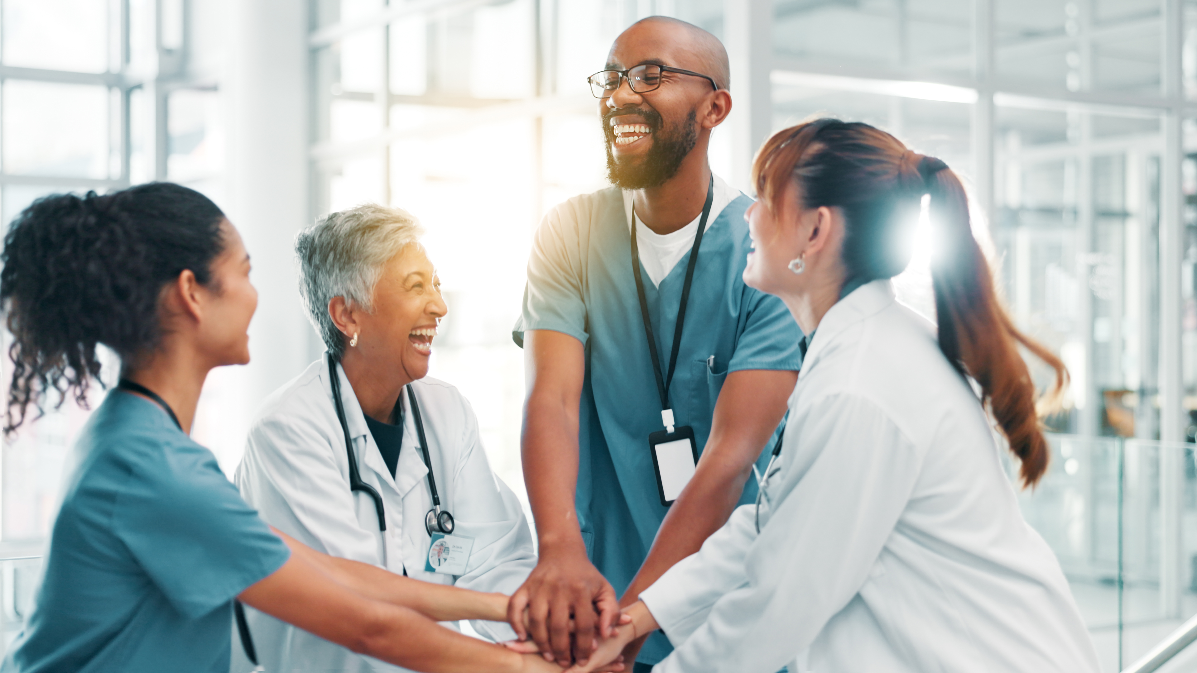 Why Integrated Healthcare Solutions Are Essential for Your Clinic's Success Hands Stack Doctors And People In Hospital Smile 00c4652e28832ba169b2