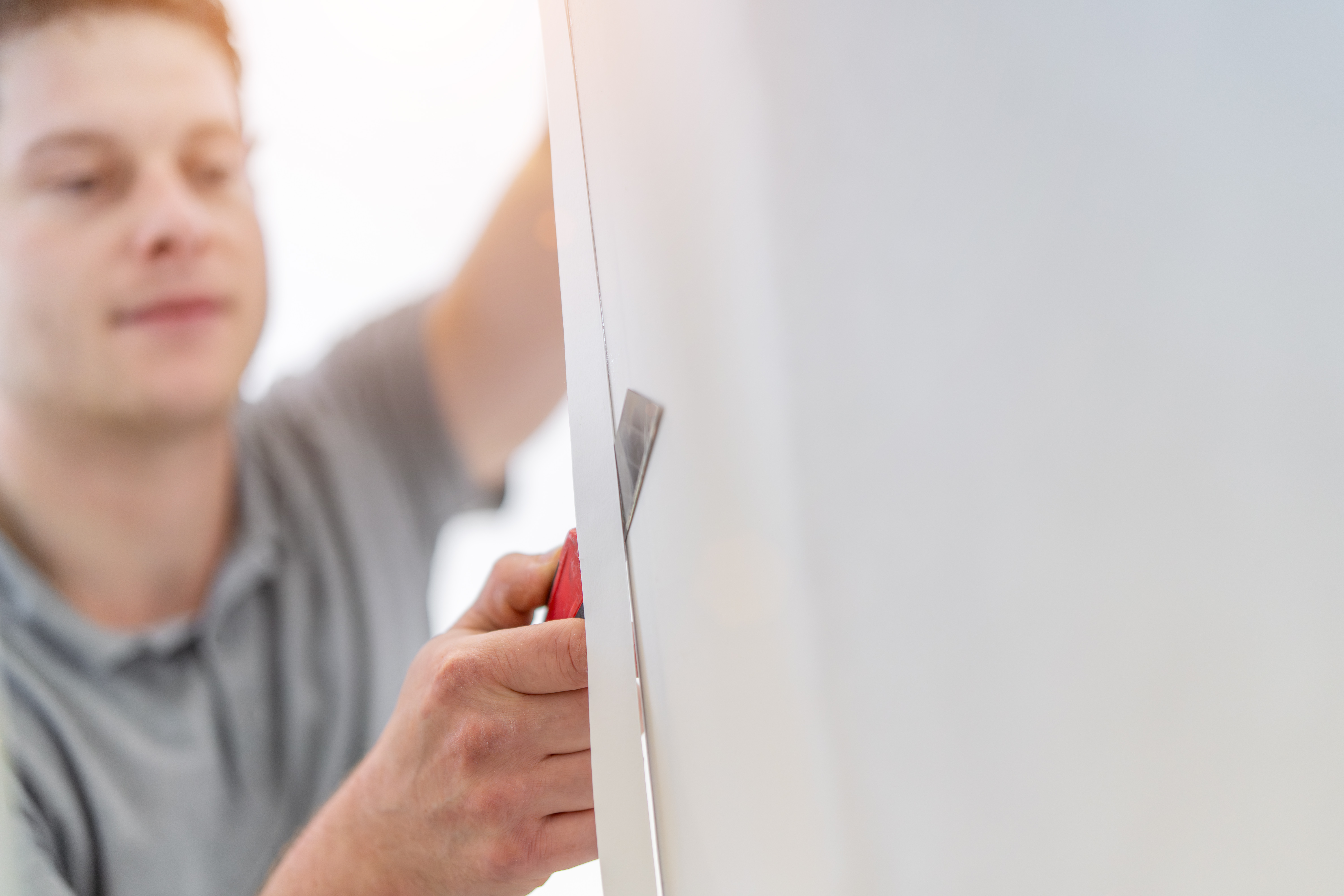 Hidden costs of low‑quality plastics in trade and DIY projects (and how to avoid them) 3 handyman man wallpapering working with tools diy 55d7d75dfadc11b4b308