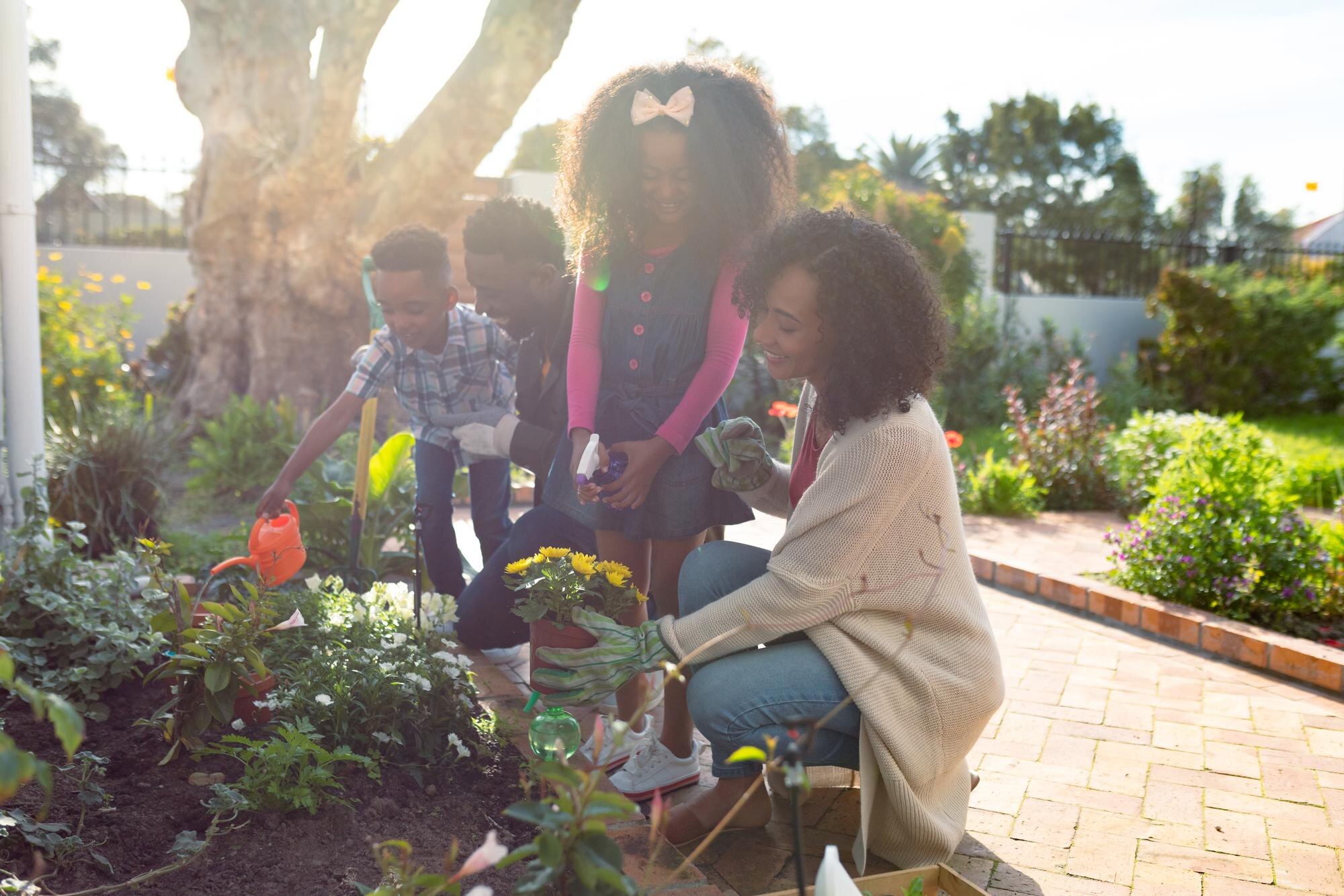 The Surprising Ways Gardening Can Boost Your Mental Health Every Day Happy African American Family Planting Flowers And 28e8156685904c402c58