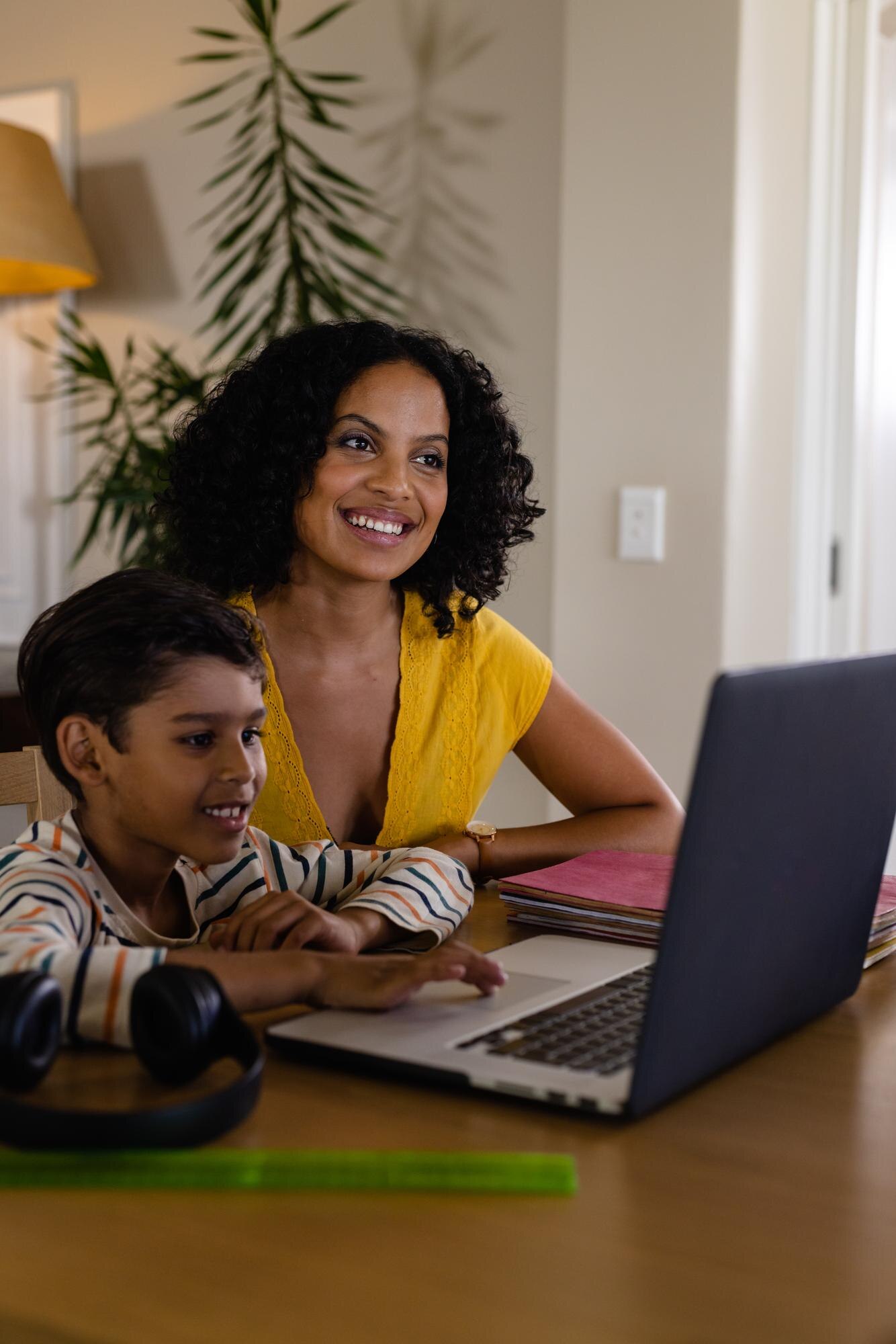 Happy Biracial Mother And Son Using Laptop Doing S 7be659442f5b2d5ab137