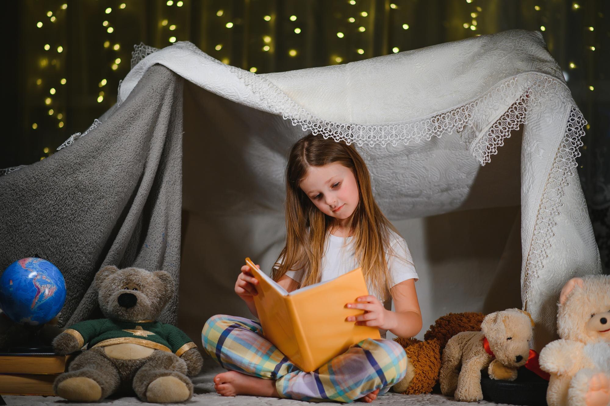 Happy Child Girl Laughing And Reading Book In Dark 2156a0fe1d1717b0ec15