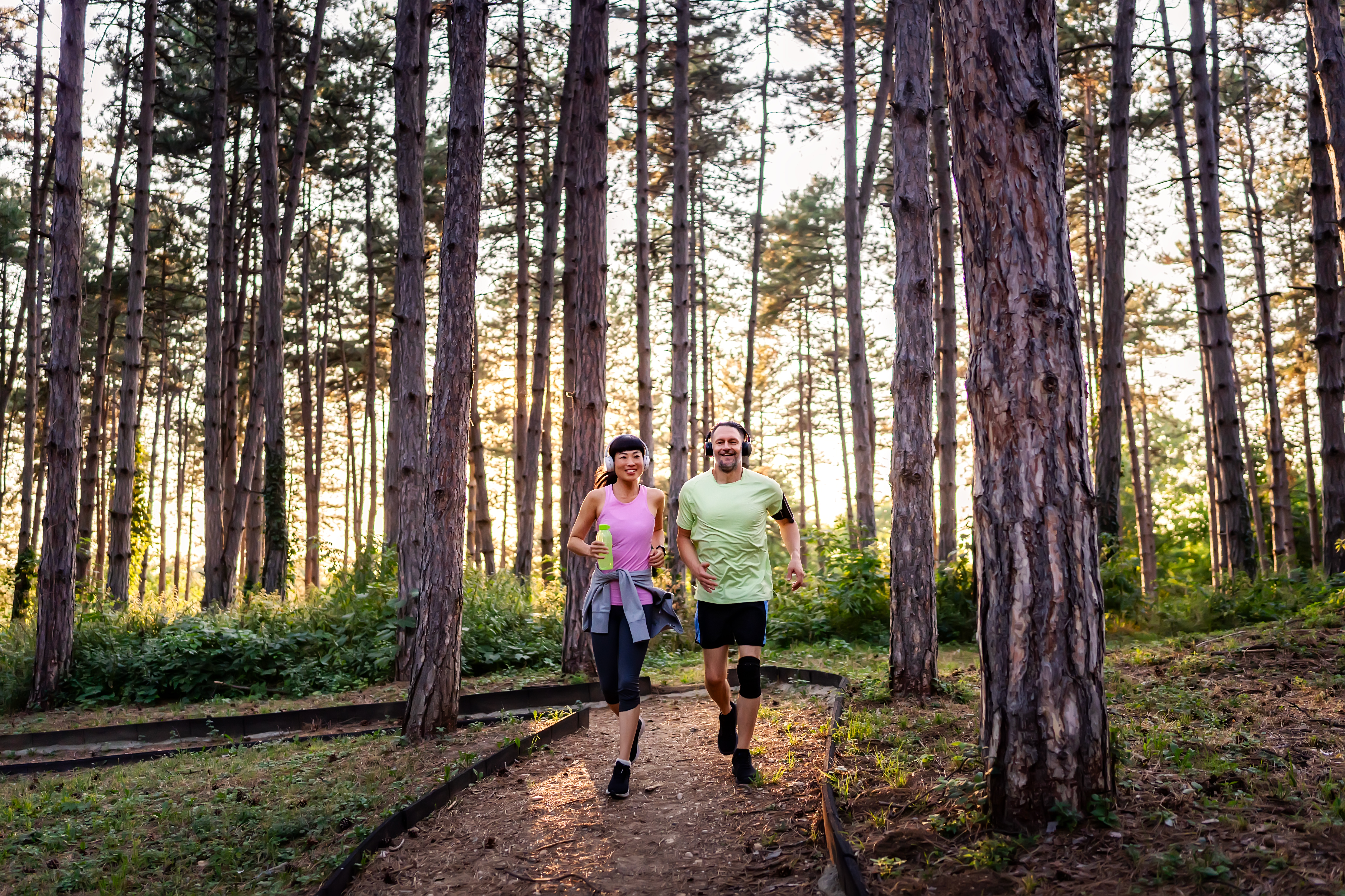 happy diverse middle aged couple jogging in forest 7d5c48015d19dcd9b341