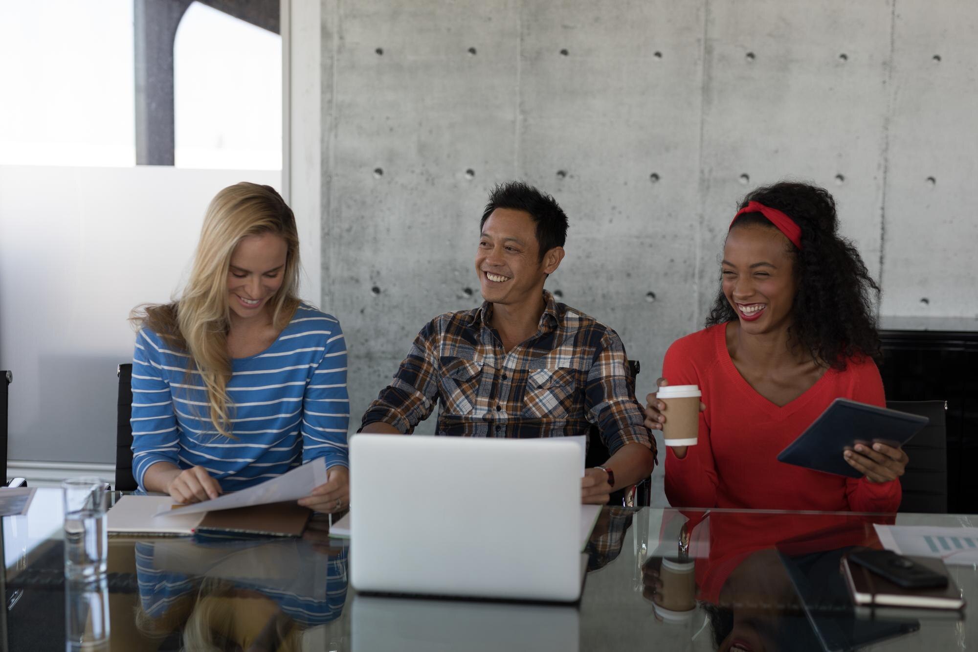 Unlocking the Power of Communication: Strategies for Building a Stronger Workplace 1 happy executives working at table in office 5f82acb493e4b972022f