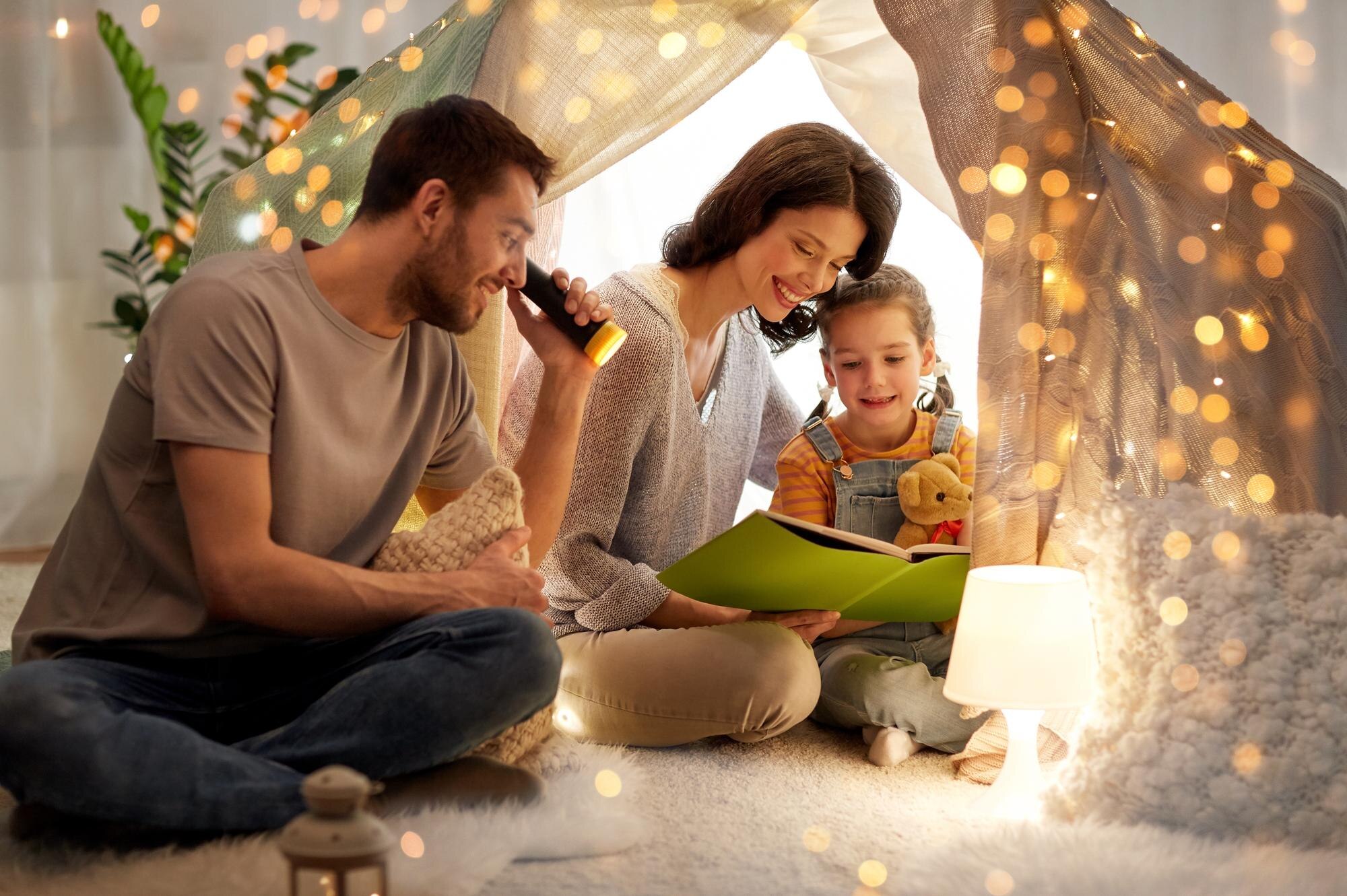 happy family reading book in kids tent at home bb67608e00ddc06db9b3