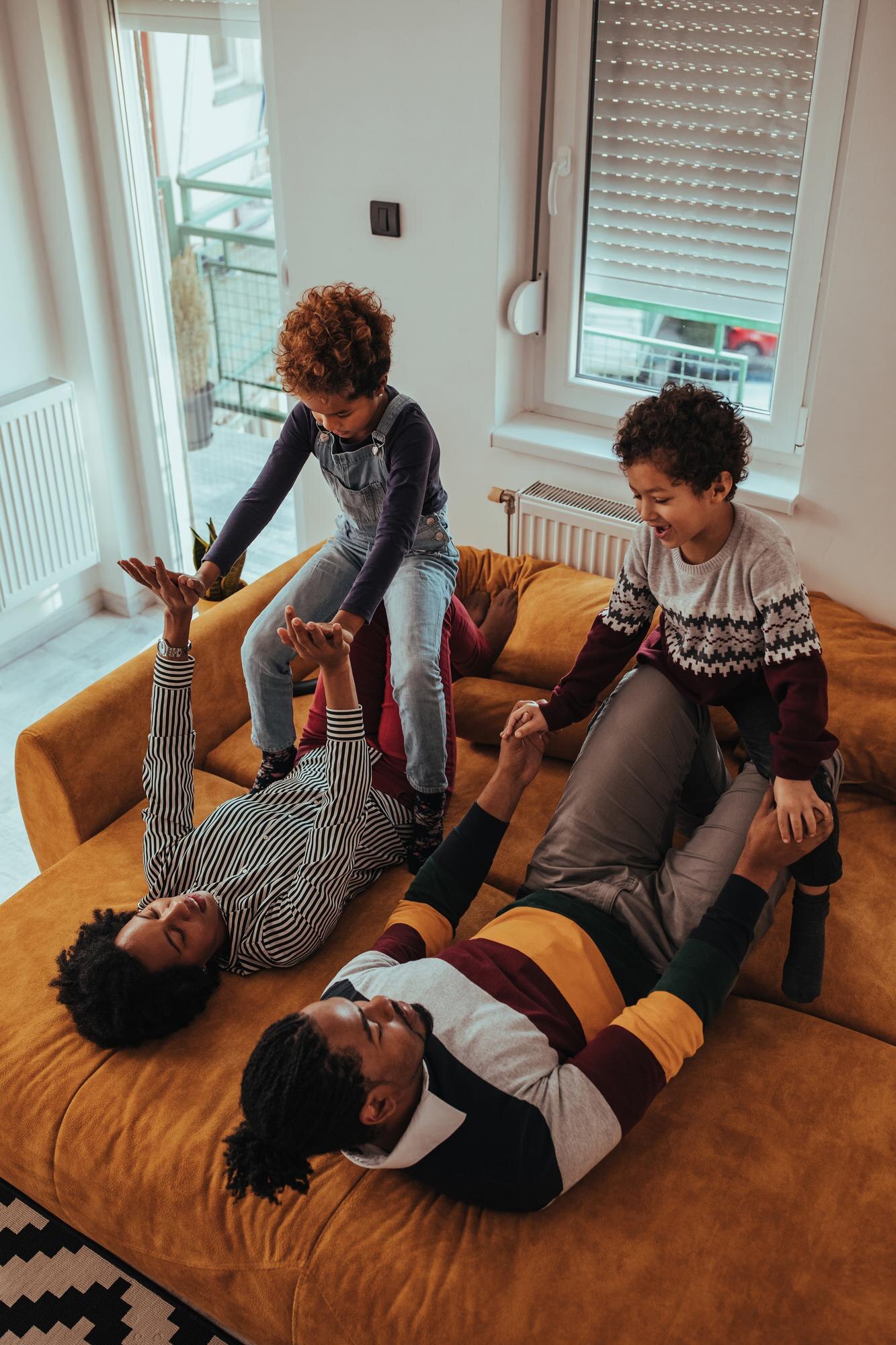 happy family relaxing on the sofa together at home 517b381e0d321367c519