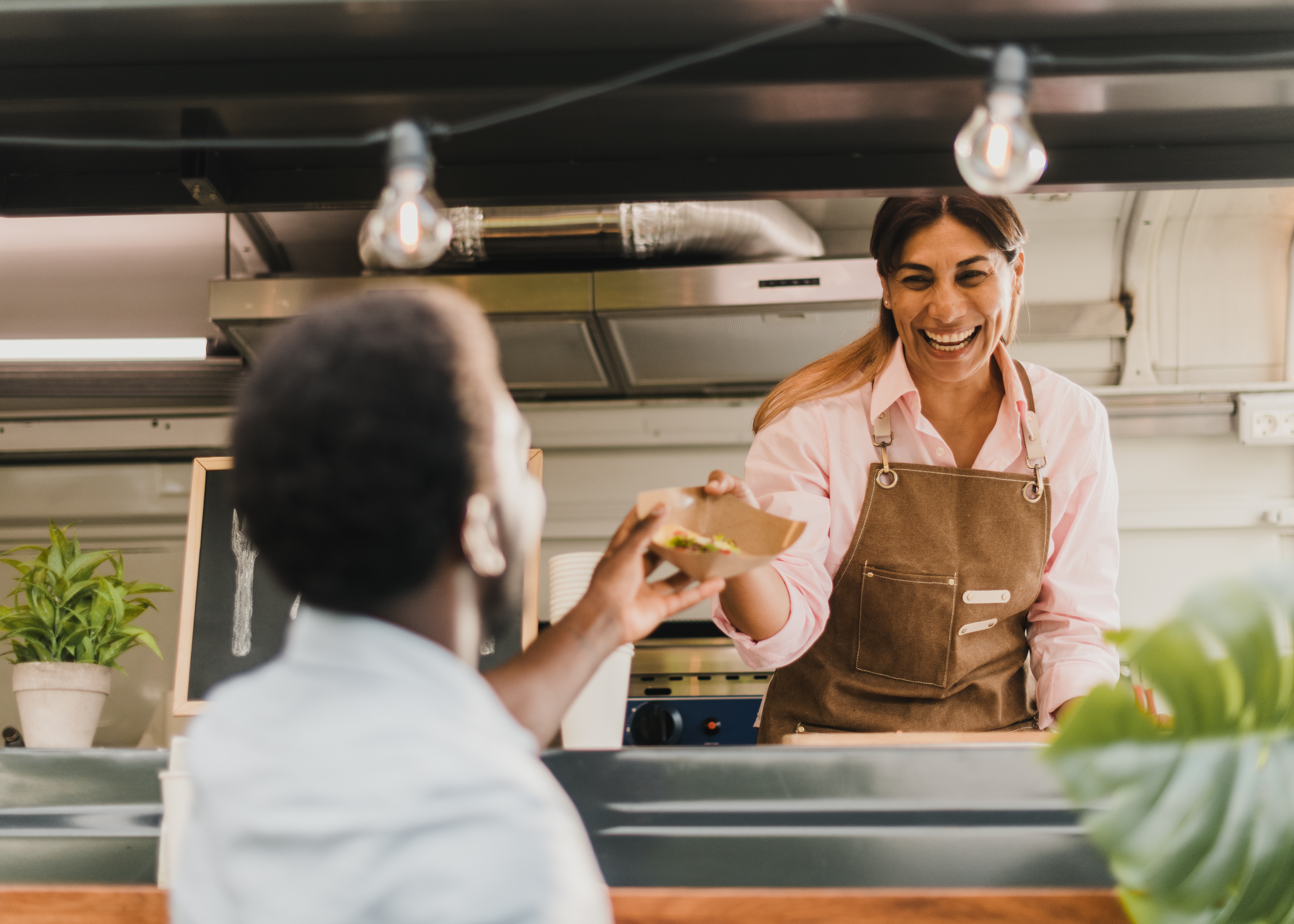 Family-Owned, Flavor-Driven: How Jubilee Juice & Grill Delivers Unmatched Quality and Care—Every Day! 3 happy hispanic seller giving takeaway salad to bla 8ded341071703993d3fc