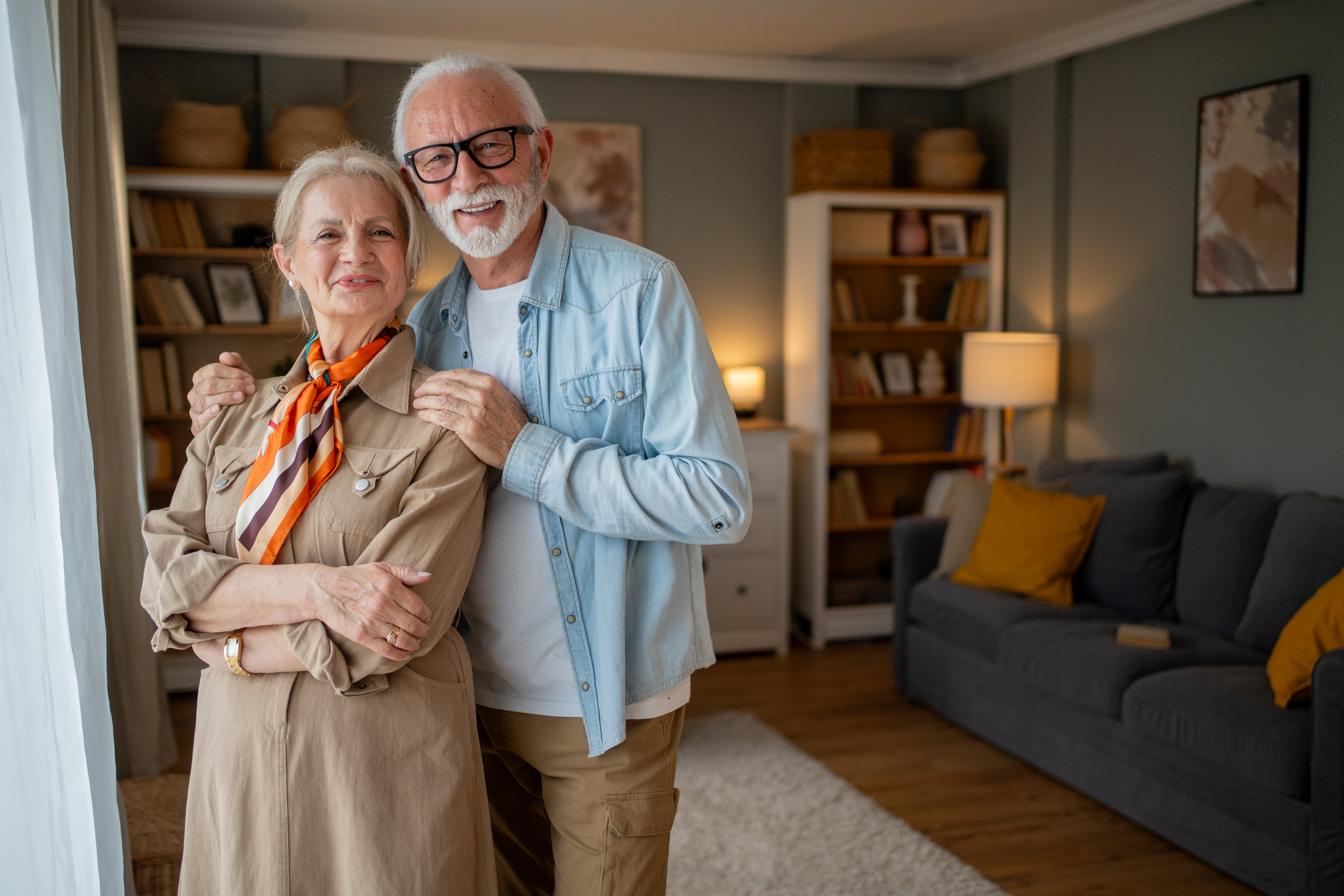 happy senior couple embracing at home in living ro a069c56346ad6b36f7bf