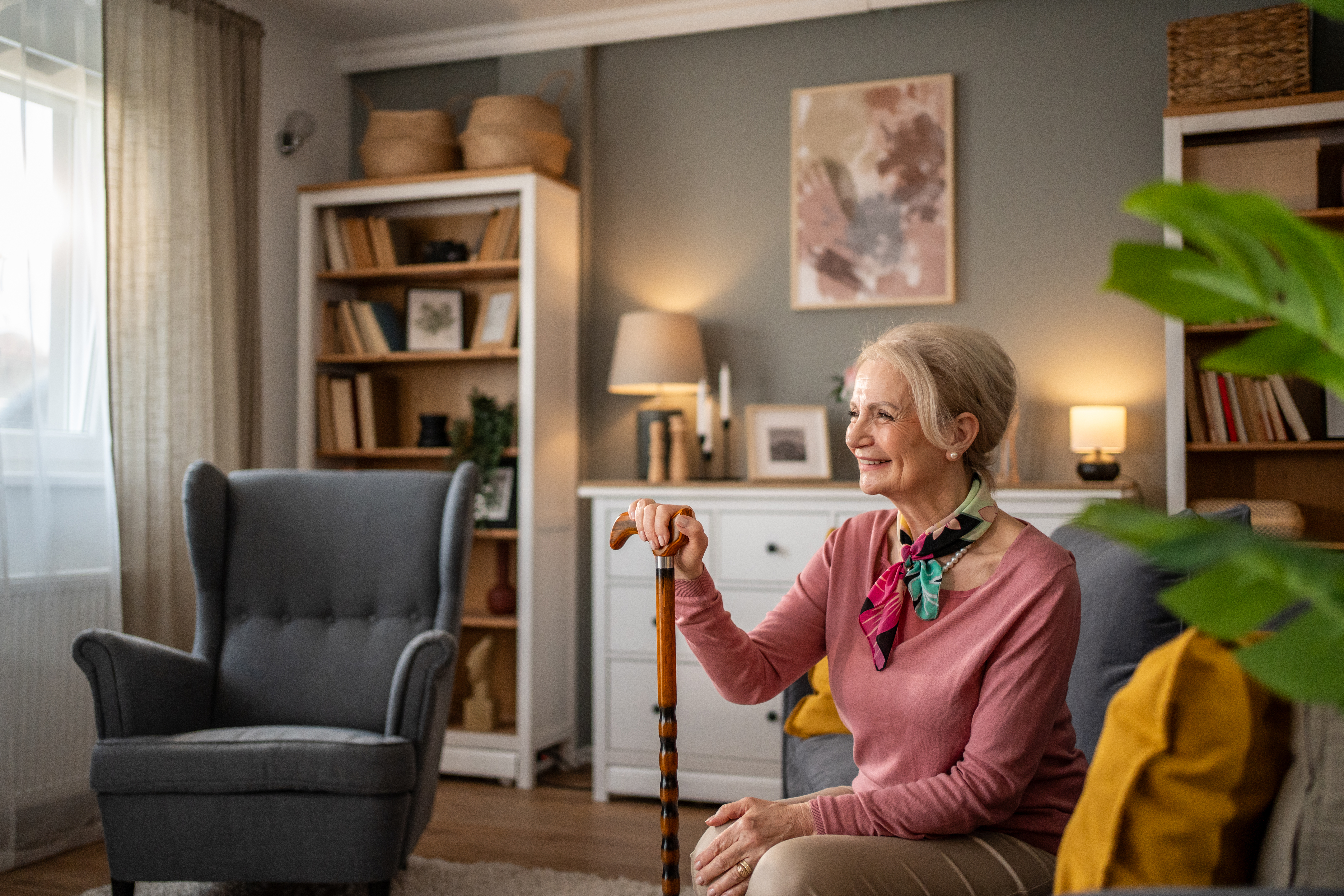 happy senior woman smiling and holding walking can 0f8f1018e672beb1bbbc