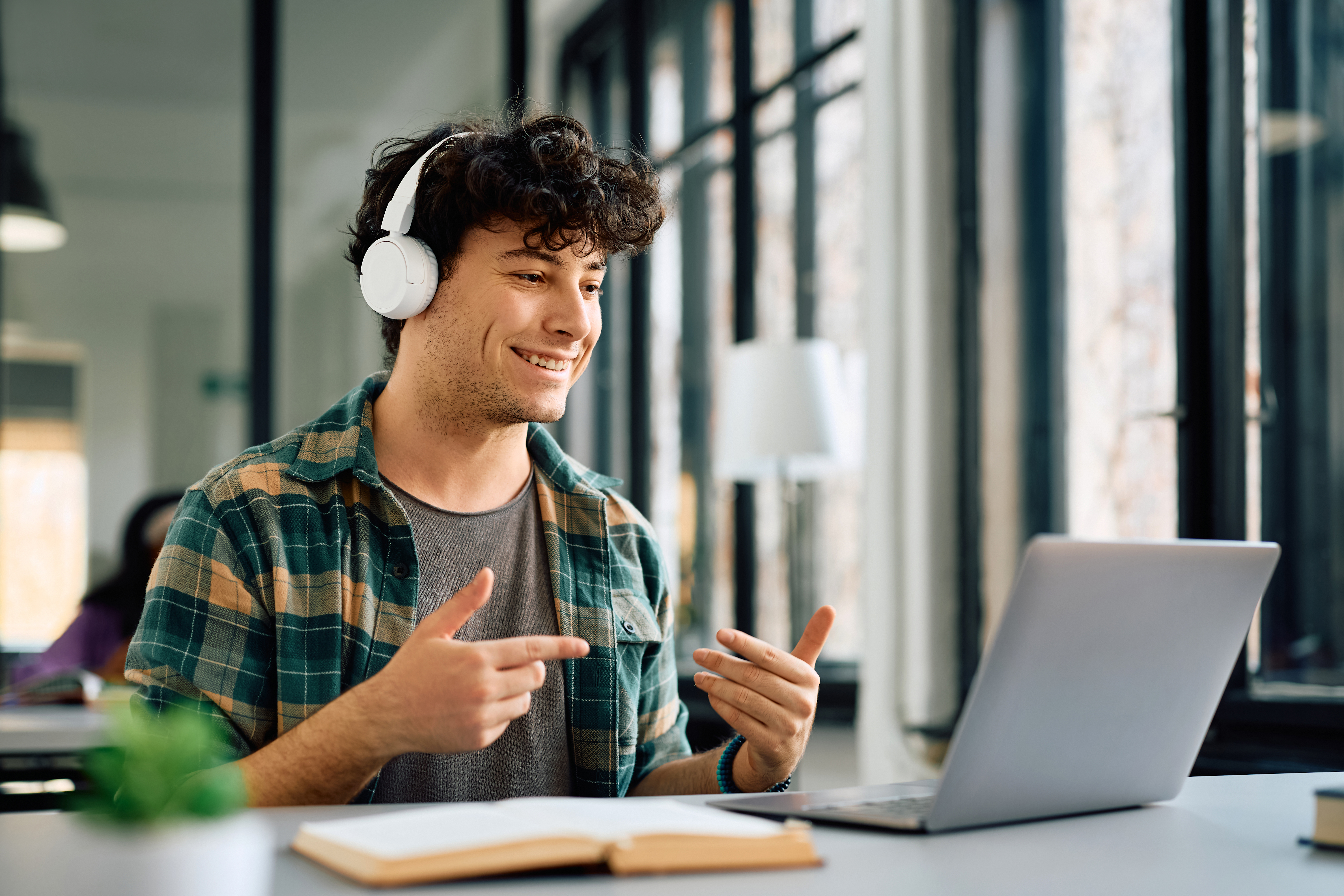 Happy Student Making Video Call Via Laptop While S 98d165f69fd7e92d2264