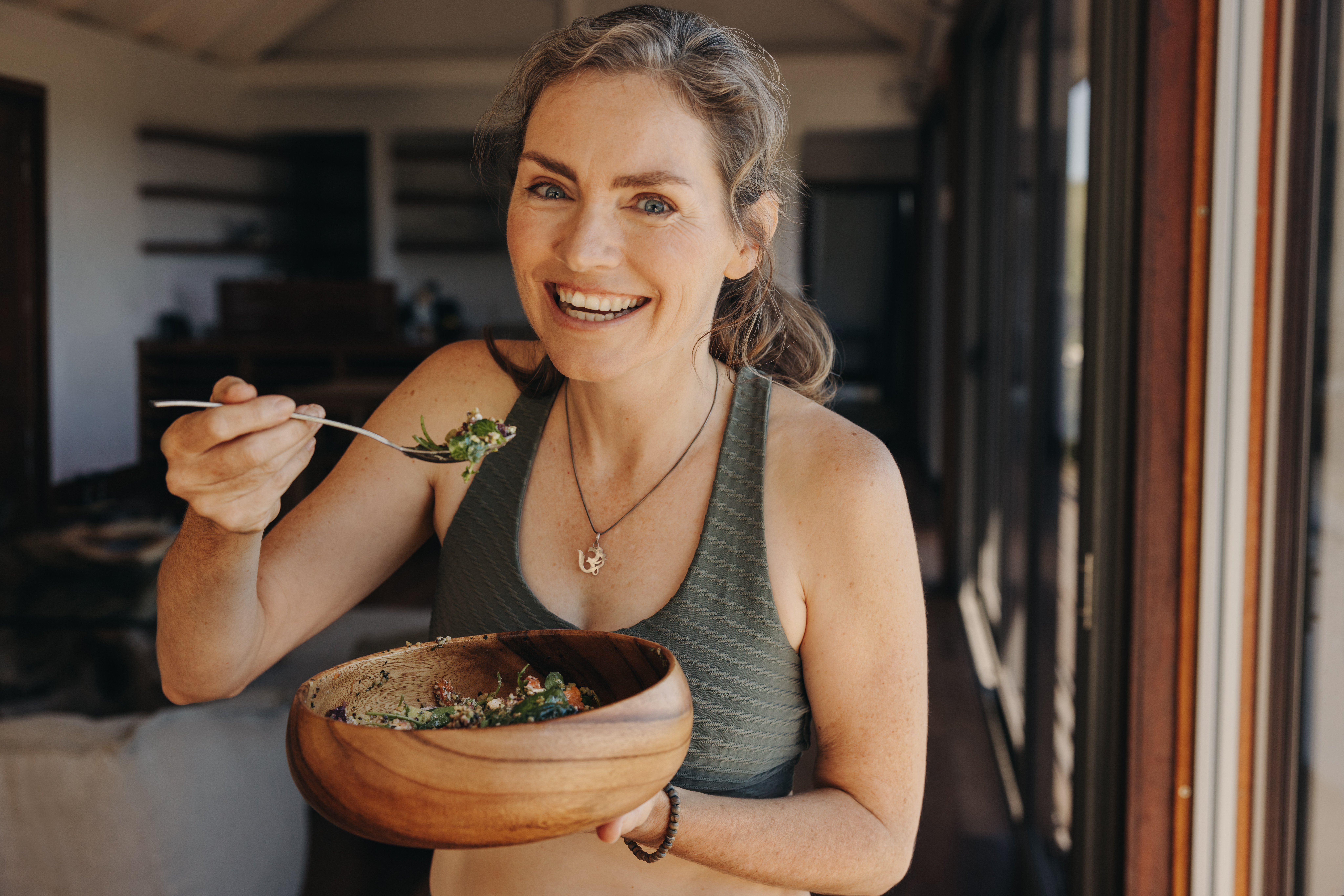 Happy Vegan Woman Eating A Vegetable Salad From A 8A90541B082C58E5B54C