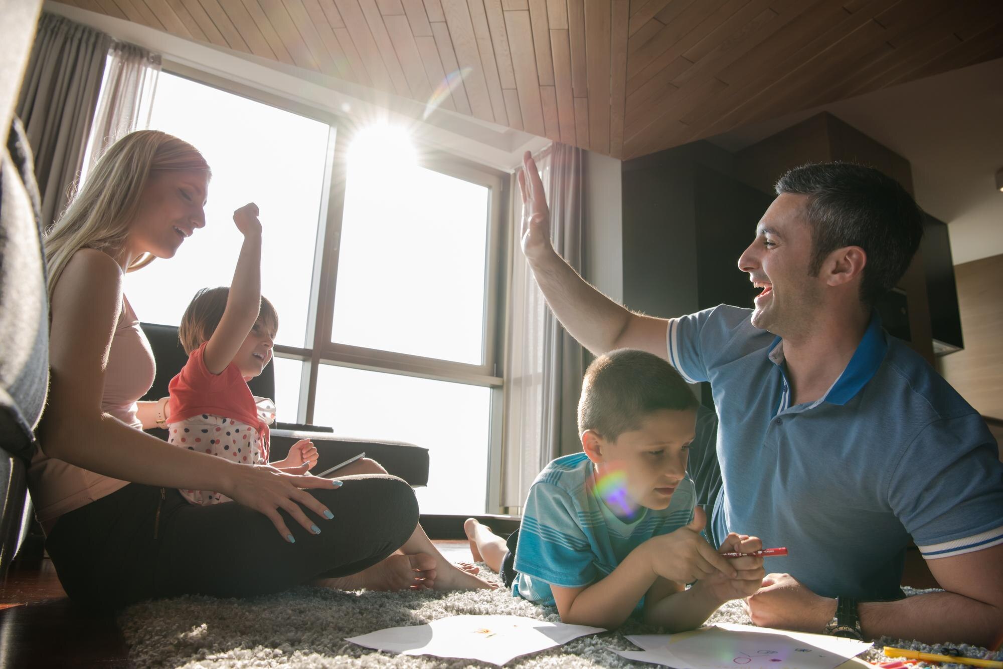 happy young family playing together at home on the b9df8f24d4bb62cdff66